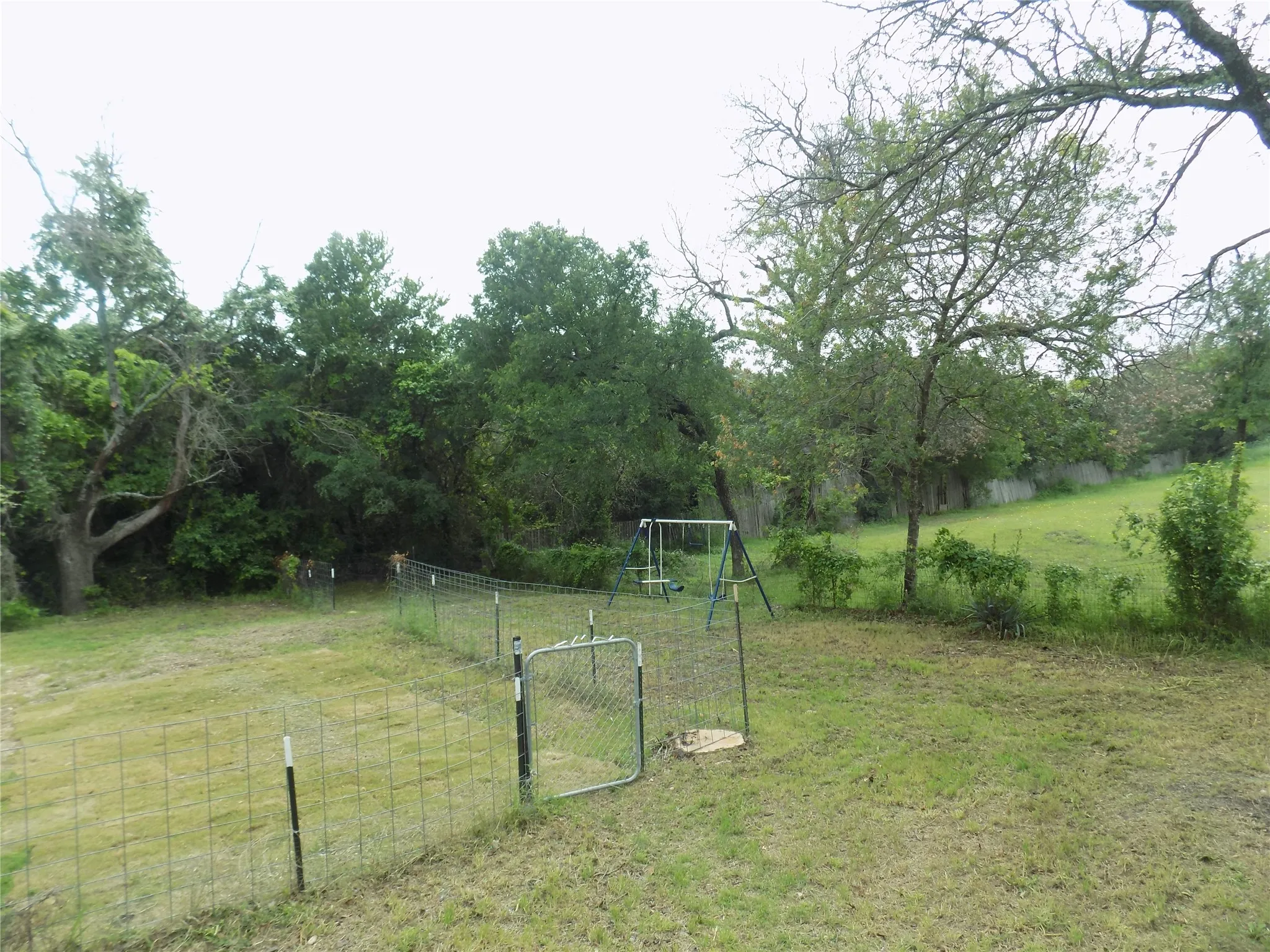 Dog run and swing set for your convenience.