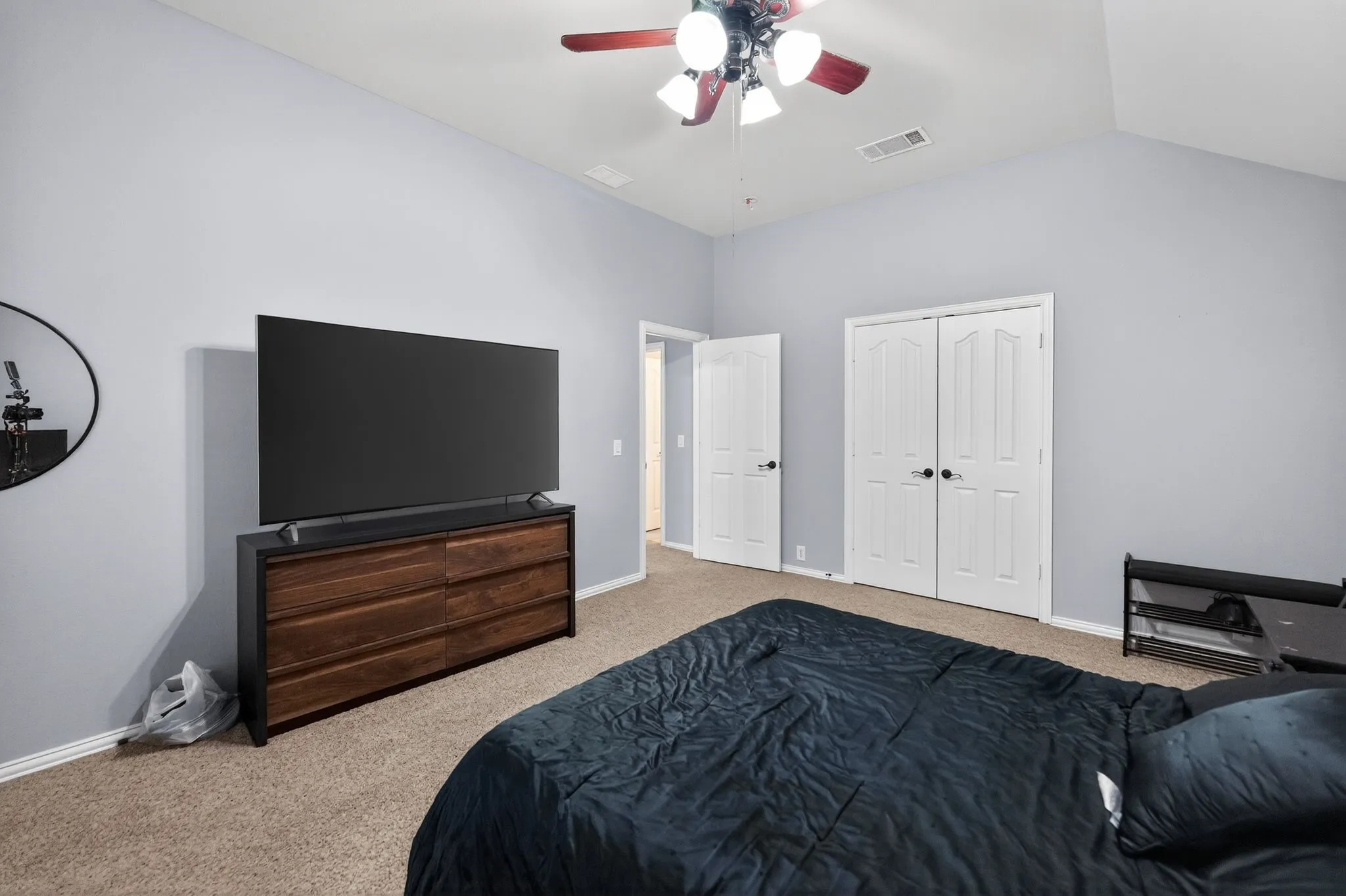 Upstairs - Bedroom # 4 featuring vaulted ceilings enhance this carpeted room featuring a ceiling fan with light fixture and white double door closet.
