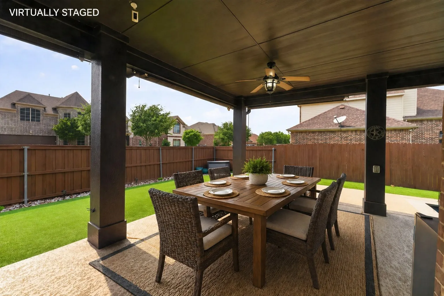 Covered patio featuring a ceiling fan and a concrete slab.