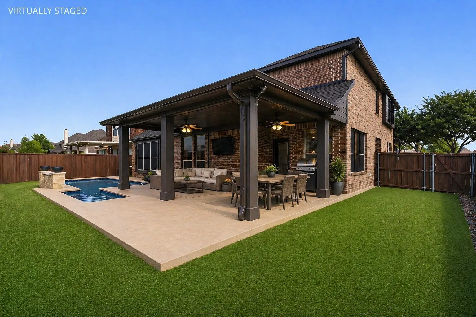 Brick exterior with a covered patio, featuring a swimming pool, artificial turf and expansive decking