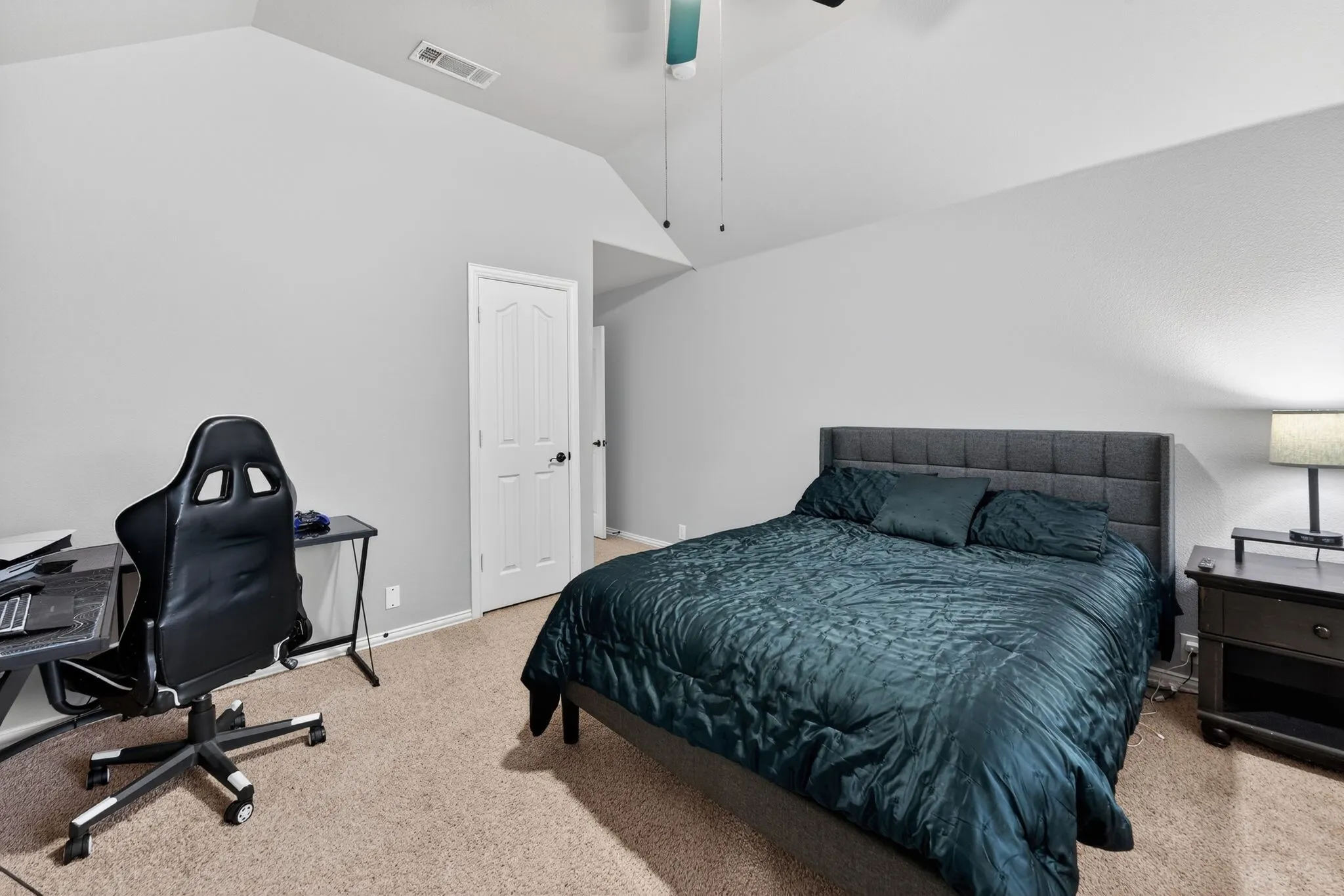 Upstairs - Bedroom # 5 featuring a textured carpet floor, vaulted ceiling, ceiling fan and walk in closet.