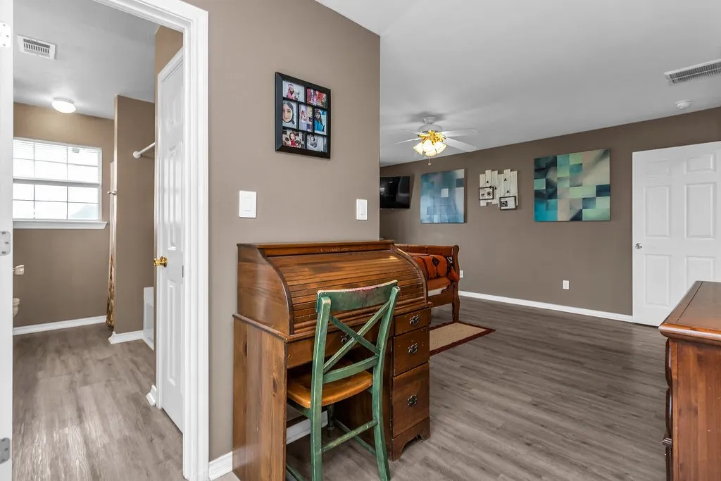 Interior space featuring wood-finish flooring, a neutral wall color, and white trim
