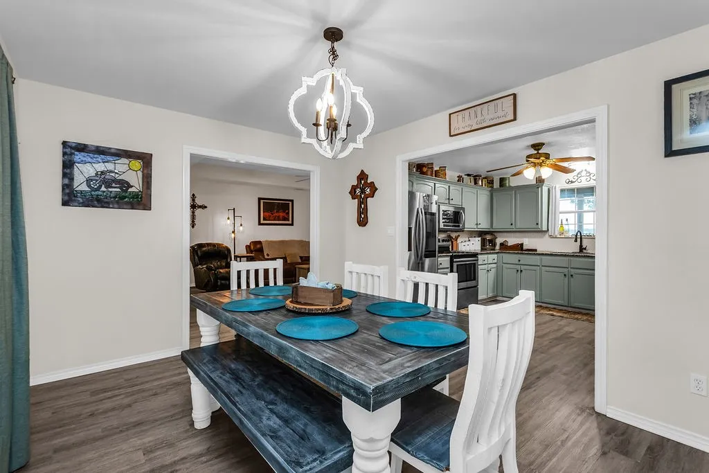 Dining area featuring a decorative chandelier, recessed lighting, and wood-finish flooring