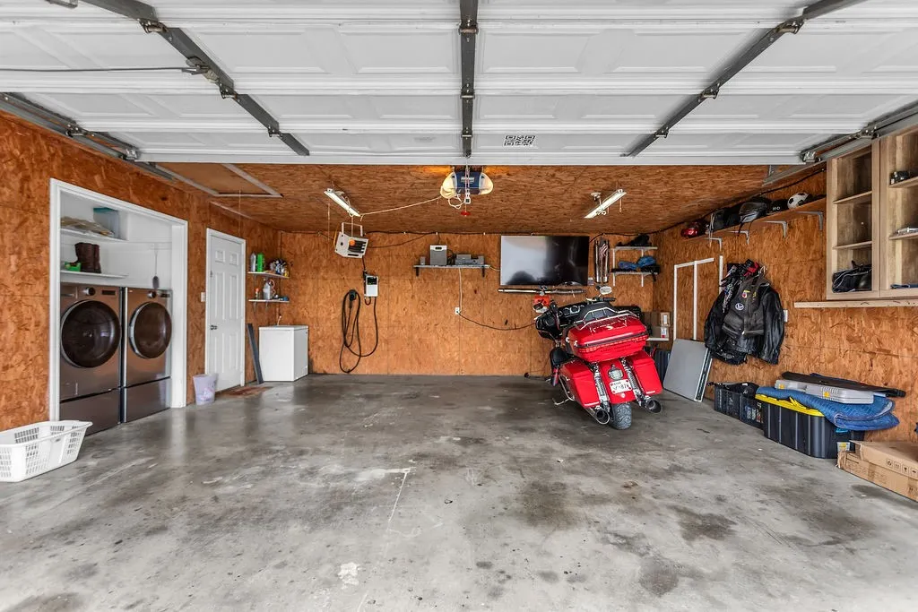 Spacious garage with exposed wood-finish walls and concrete flooring