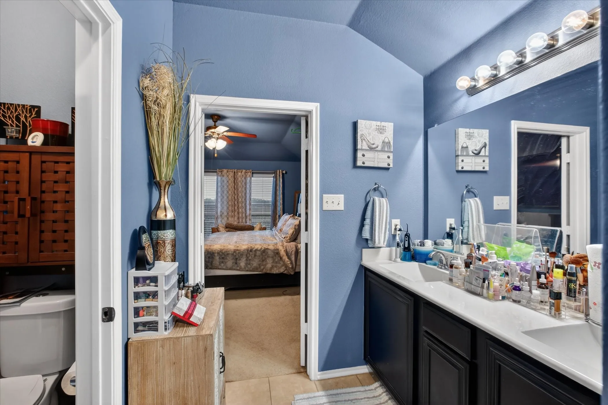 Double vanity with a light-toned countertop and dark cabinetry