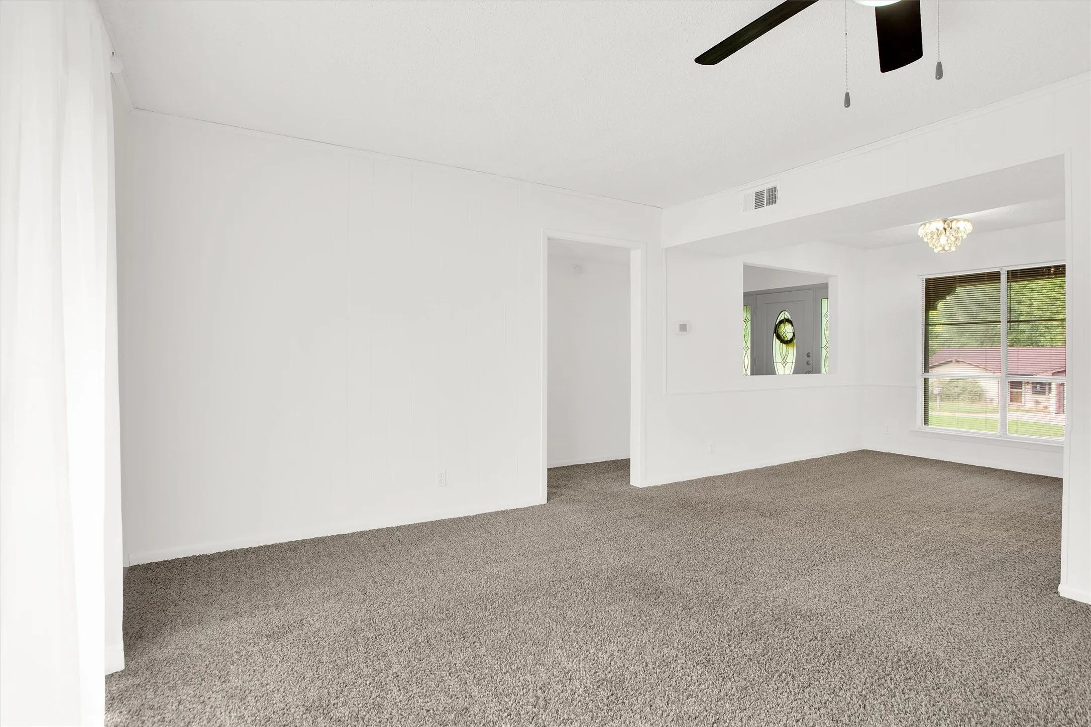 View from the living room toward the dining room and front entry.