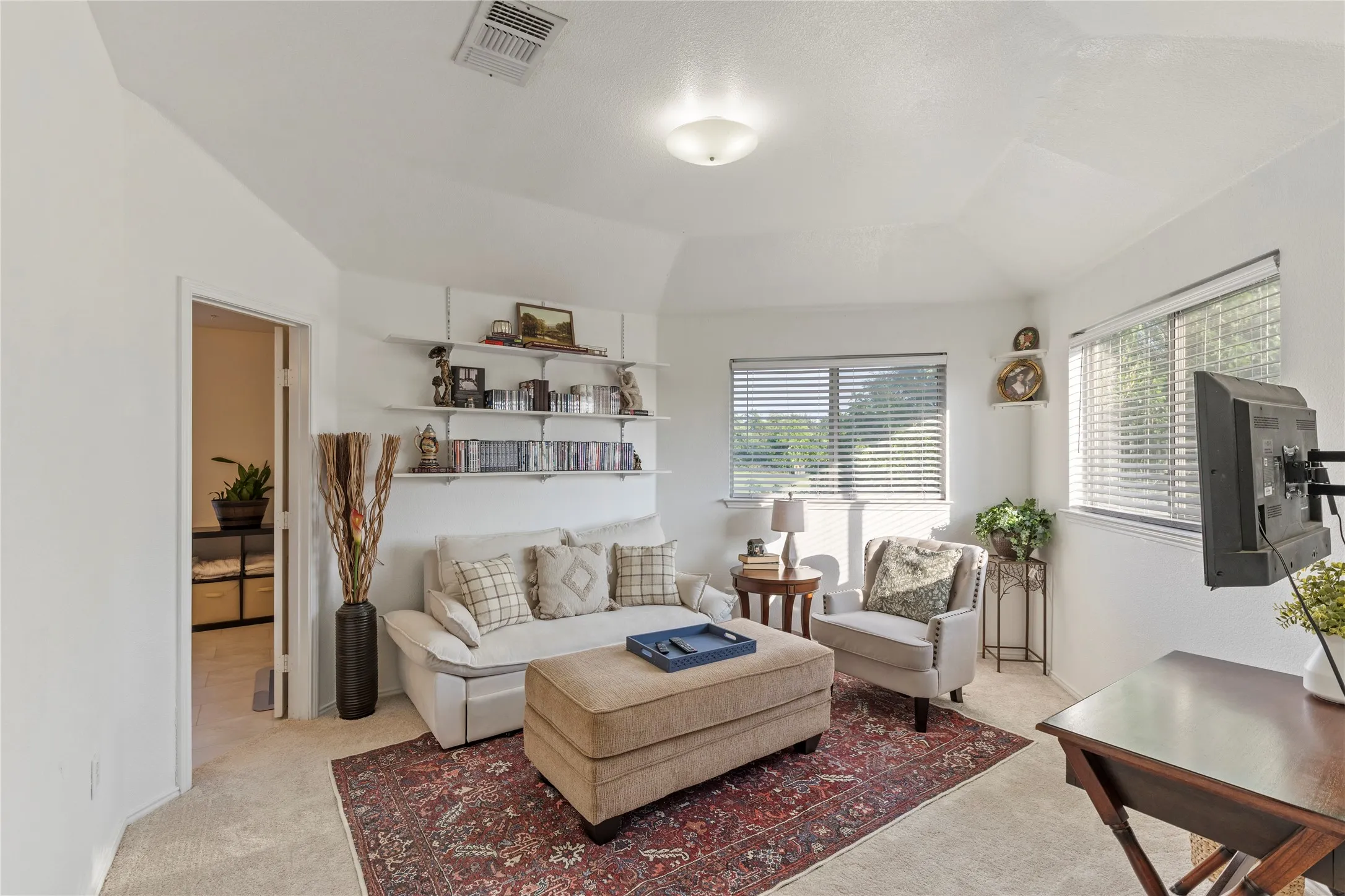 Carpeted room featuring an angled ceiling and recessed lighting