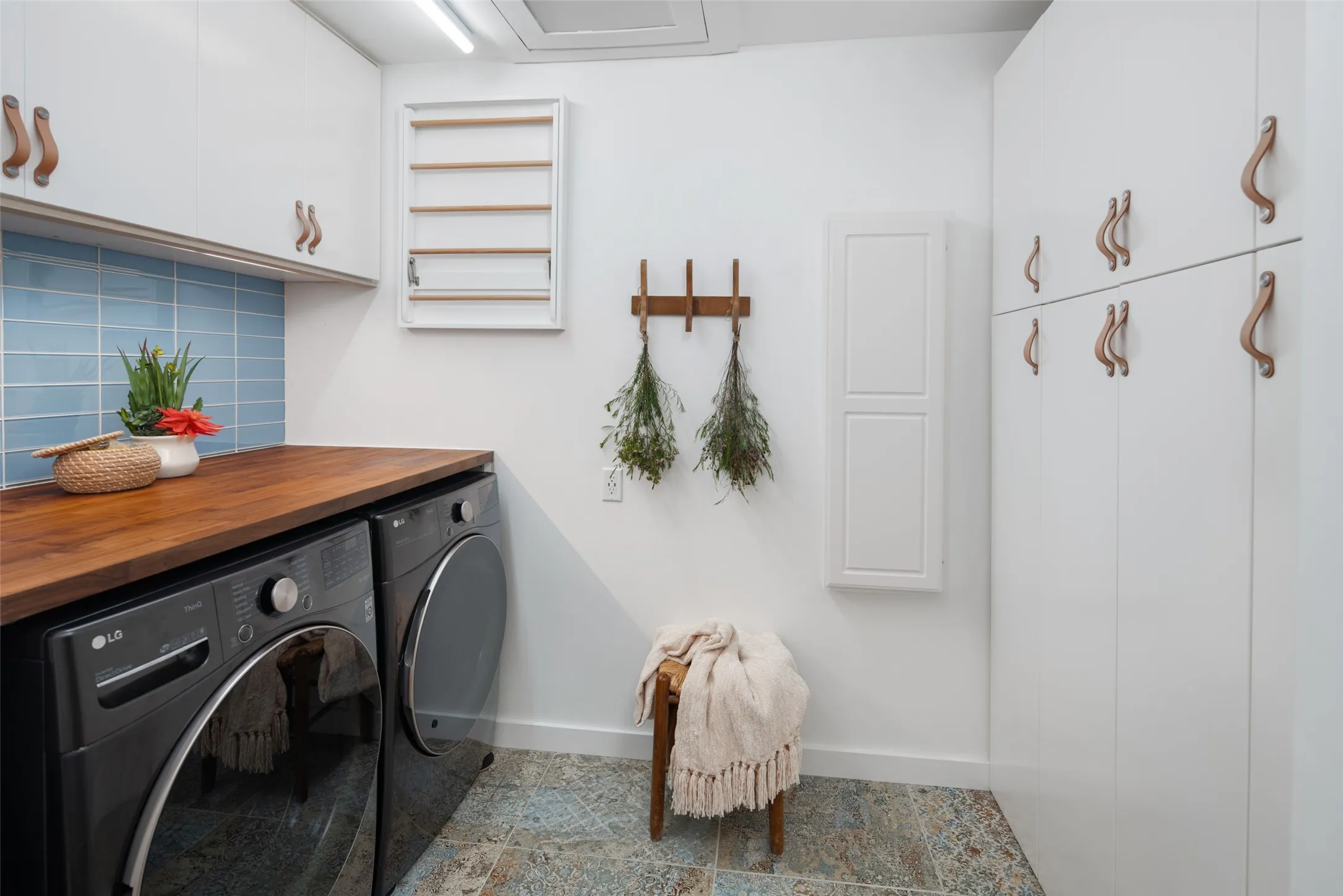 Thoughtfully designed utility room with built-in storage or second pantry