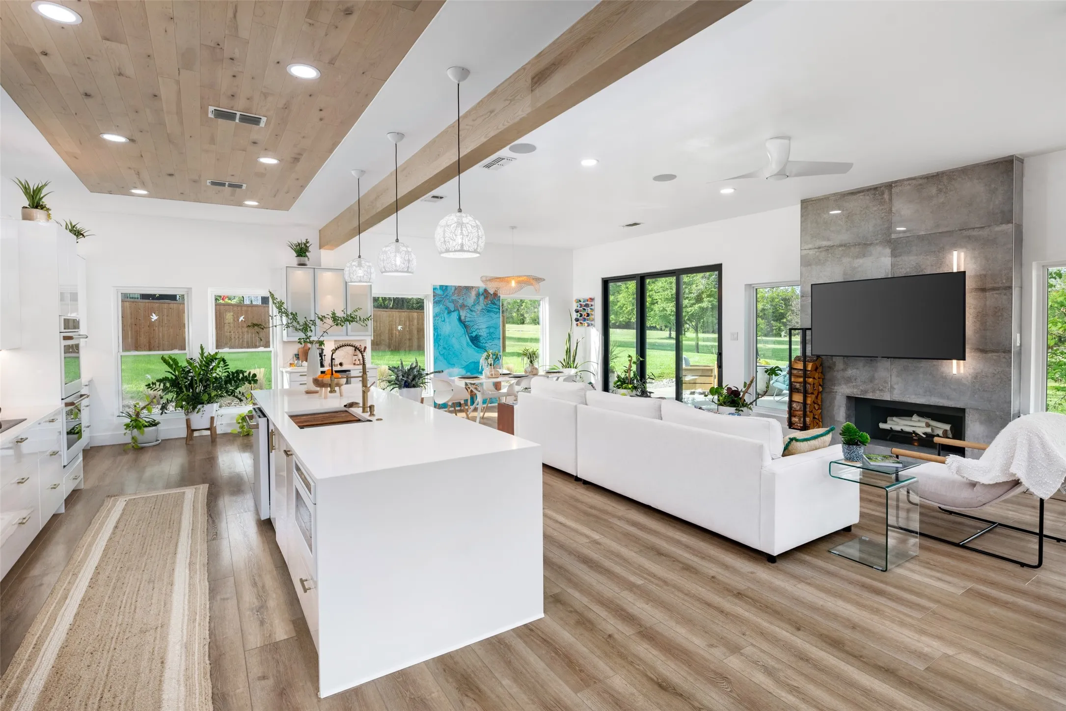 Kitchen island has a waterfall quartzite countertop