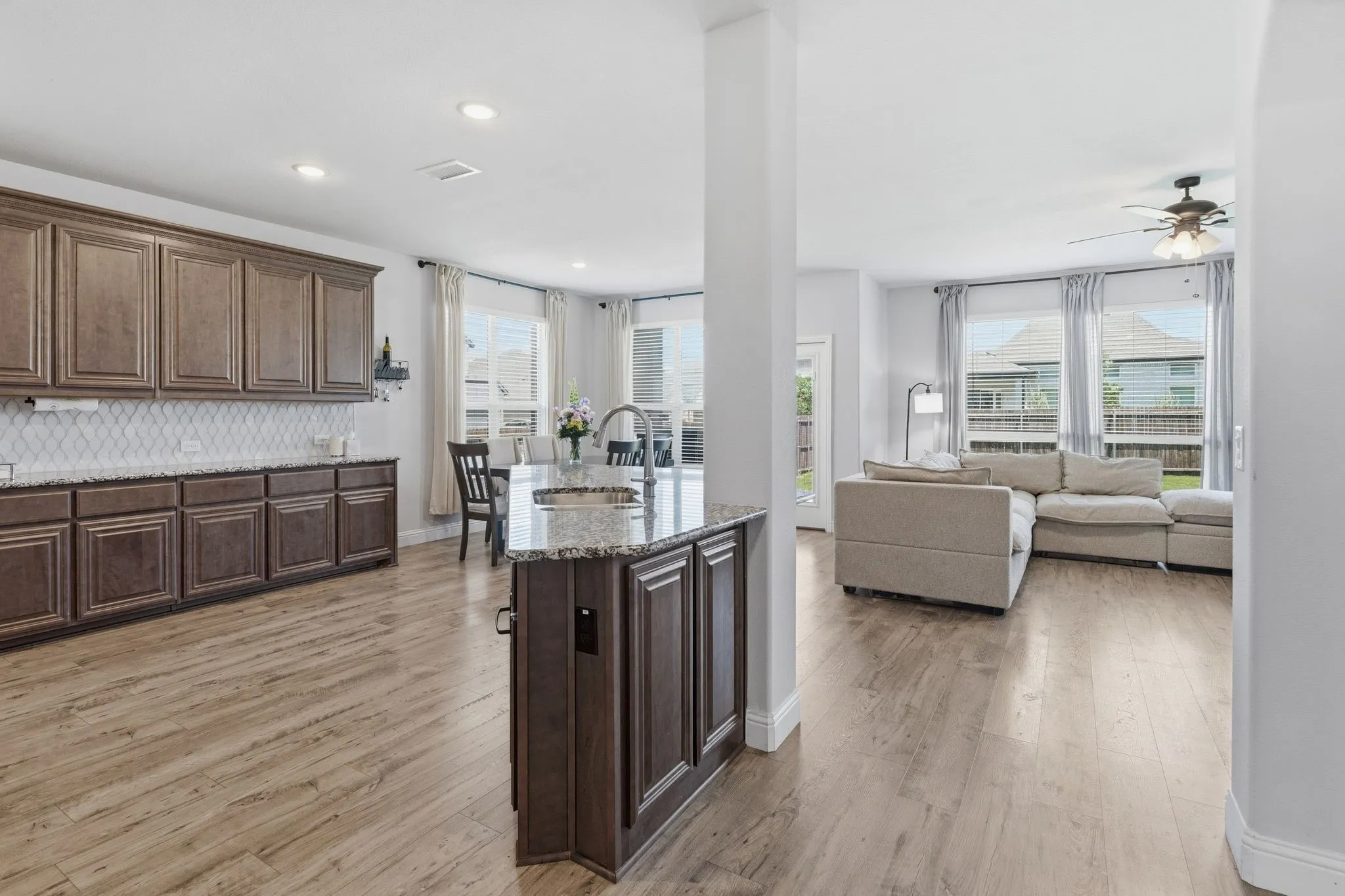 This kitchen has tons of counter top space and storage.  The island is perfectly situated for keeping up with everyone in the large open concept living space.