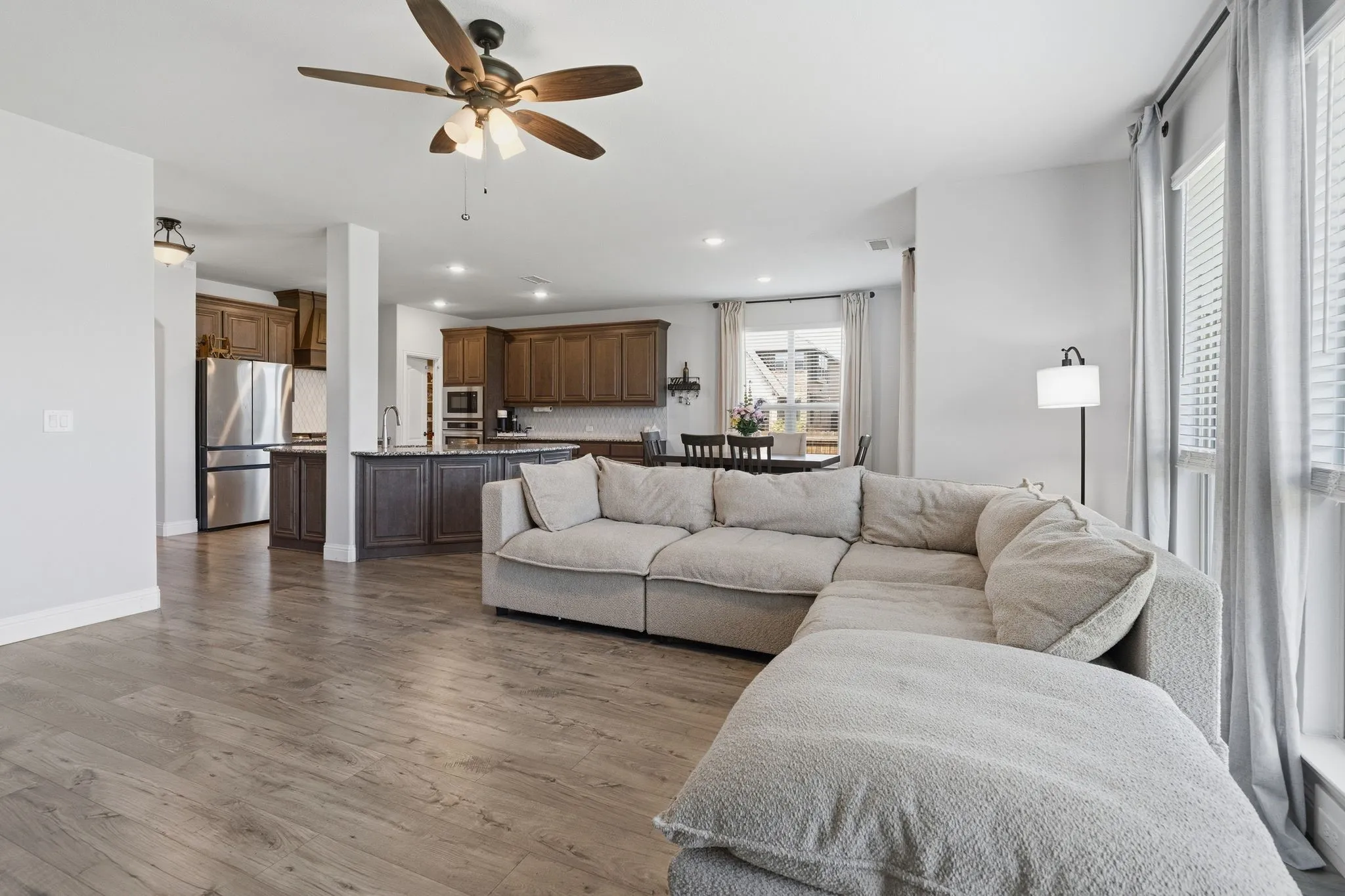 Very spacious living room with easy flow to the kitchen and dining space.  Never miss a minute of the fun while enjoying this arrangement! Making entertaining a breeze!