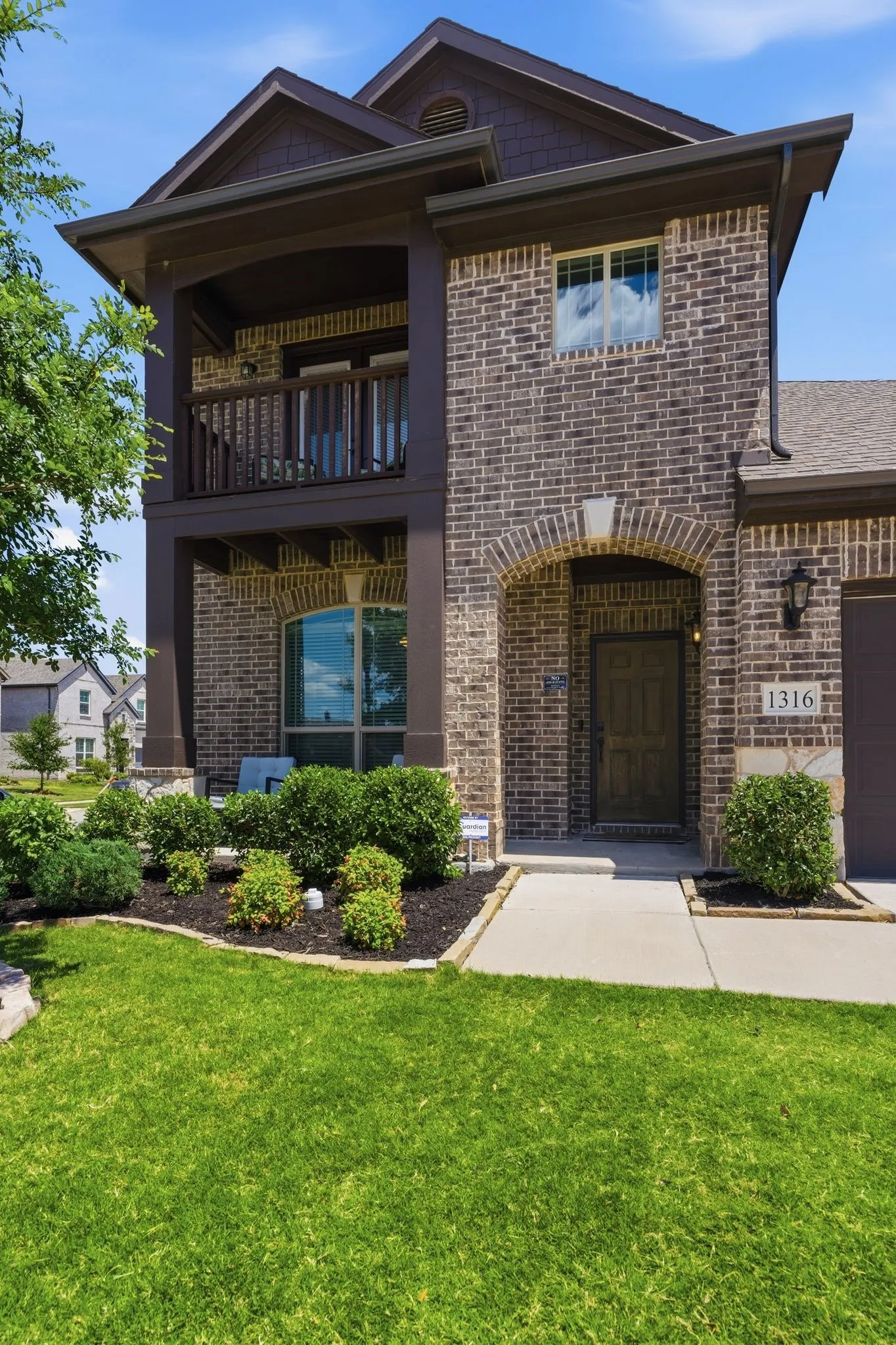 Enjoy the covered front porch and the upstairs balcony at this home.