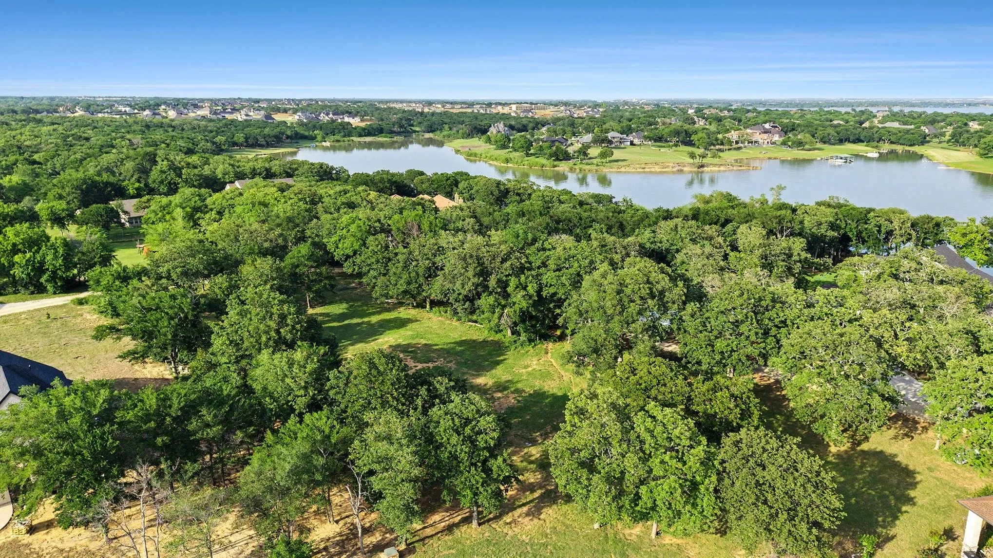 Wooded homesite with partial clearing along Lake Lewisville in Braewood Bay.