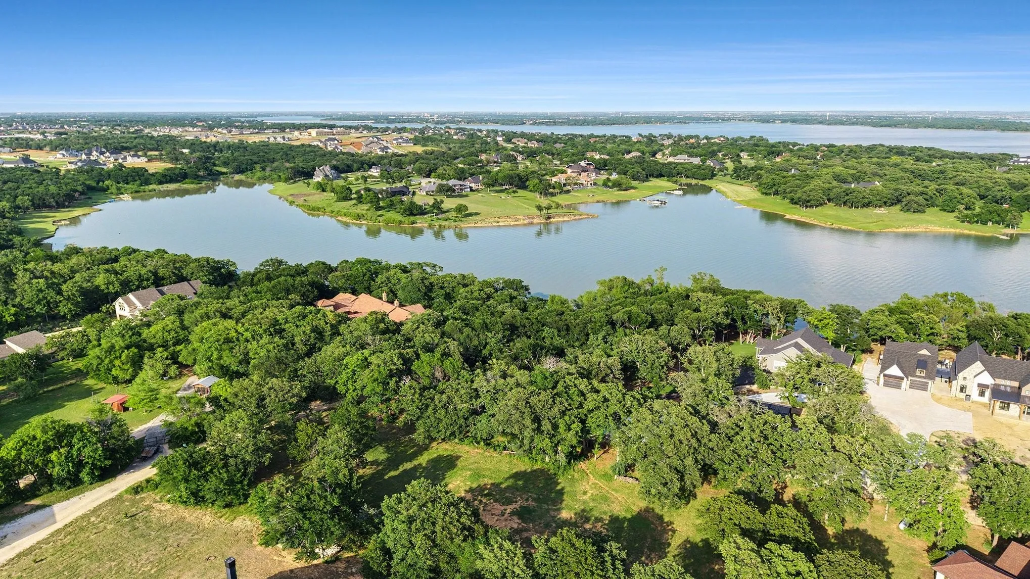 Aerial view showcasing Lake Lewisville and the wooded shoreline surrounding Braewood Bay.