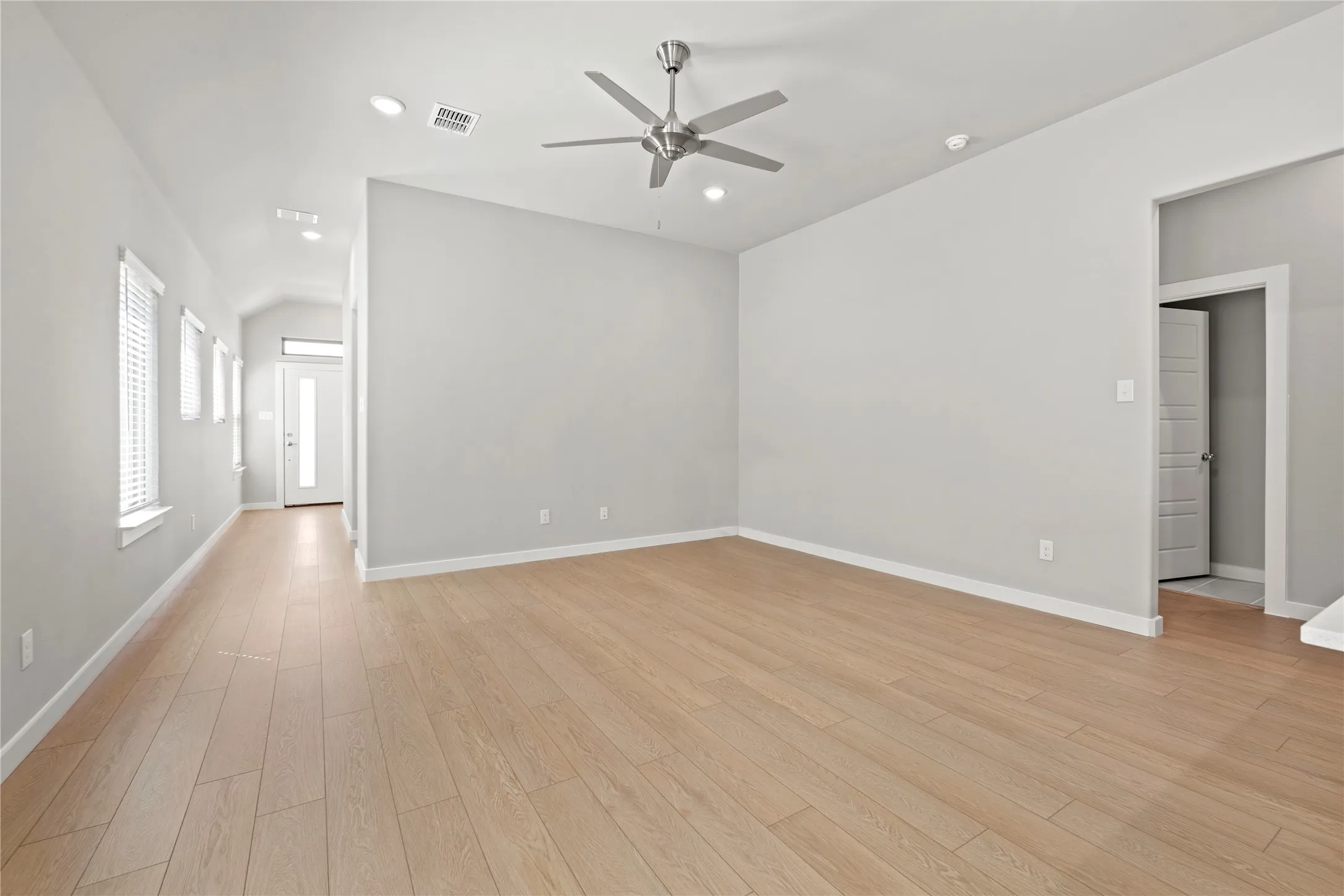 Unfurnished room with ceiling fan and light hardwood / wood-style flooring