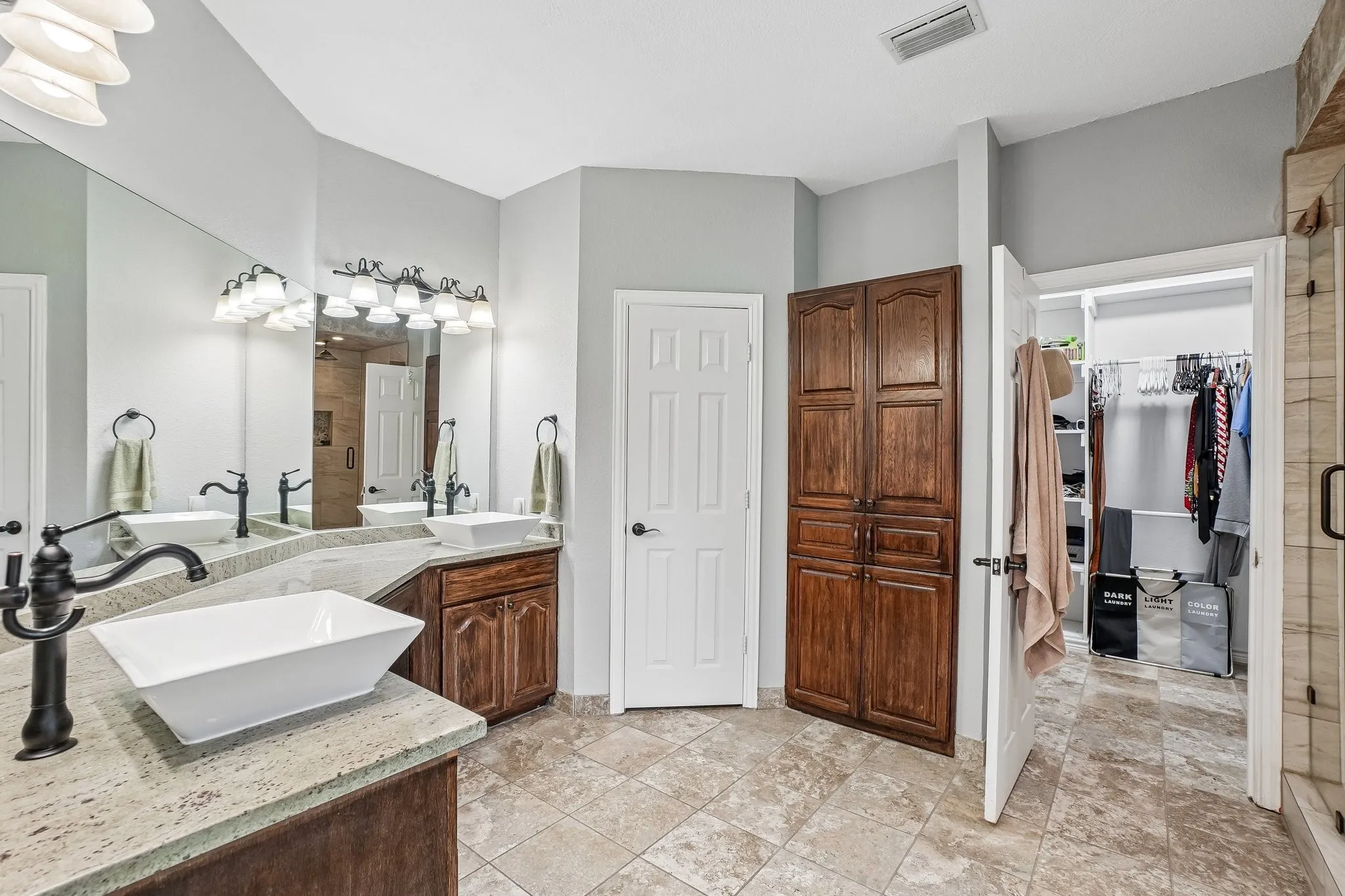 Primary bathroom featuring dual sinks with ample counter space and a functional layout.