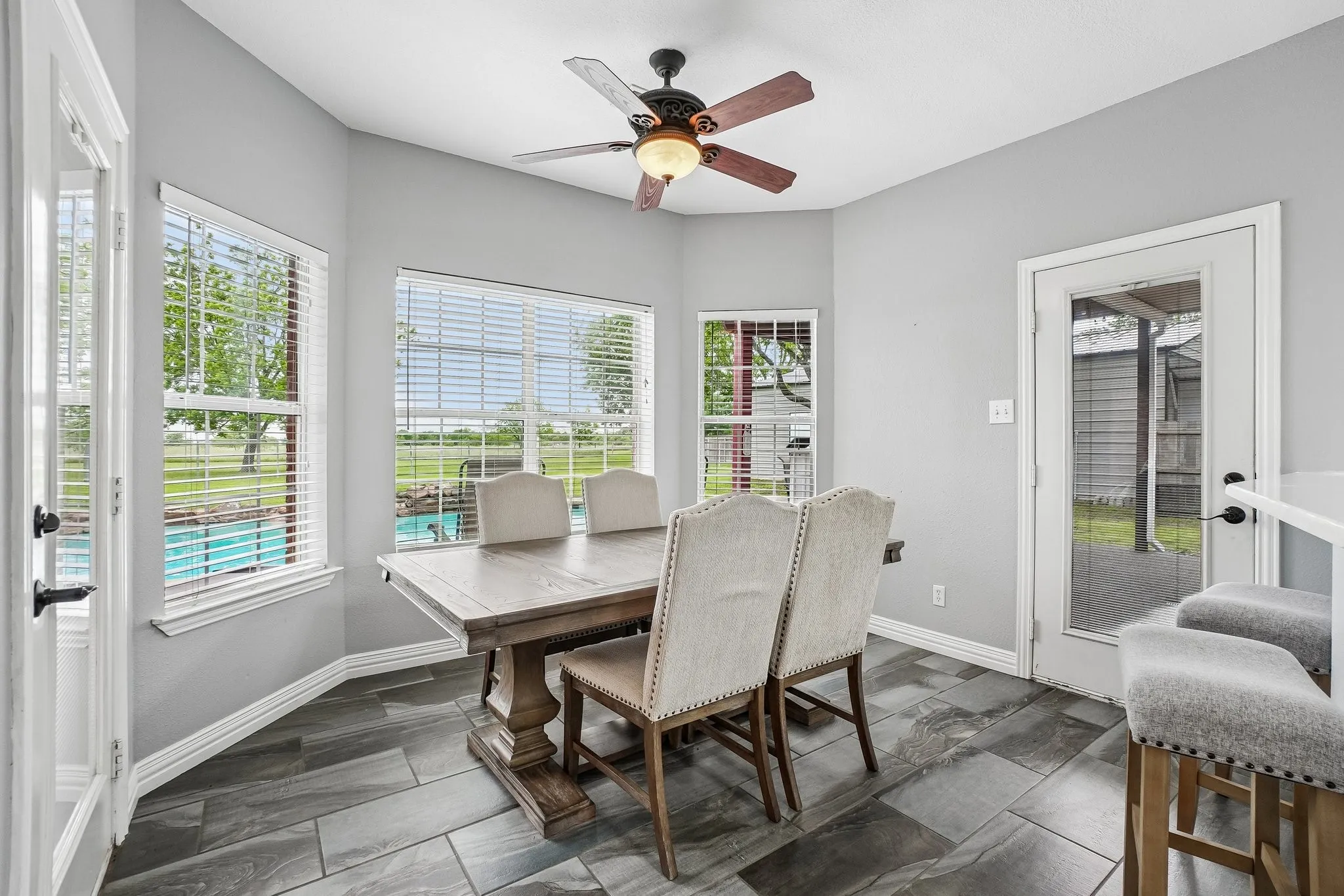 Bright dining area surrounded by multiple windows
