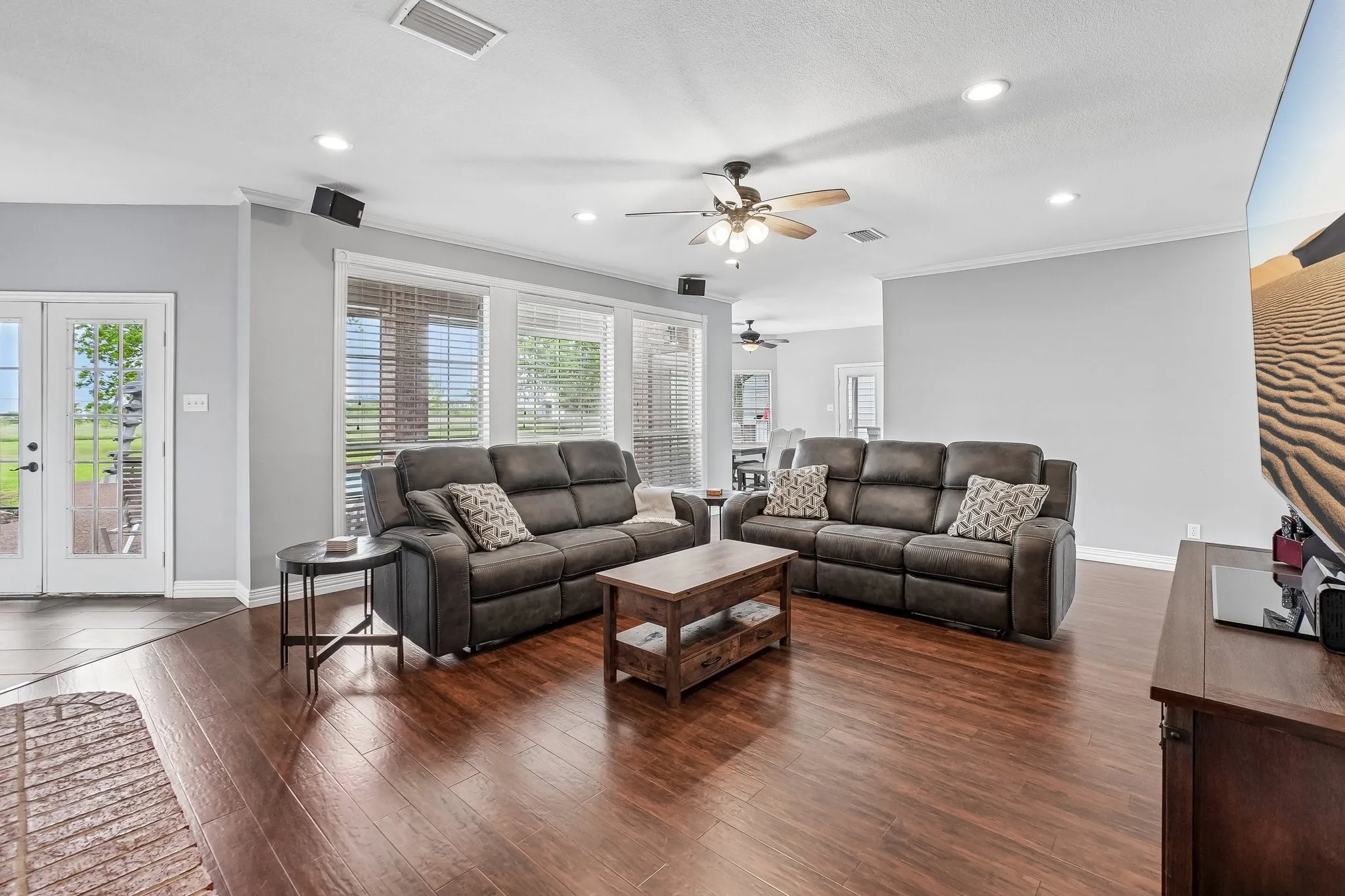 Open concept living room filled with natural light from multiple windows