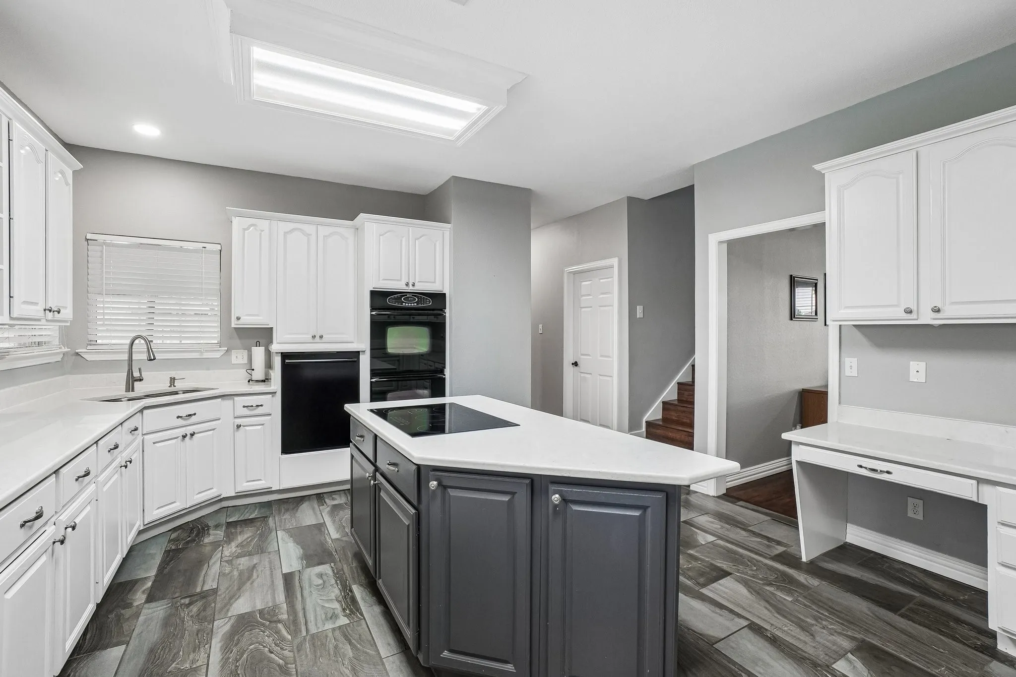 Spacious open-concept kitchen featuring abundant counter space and cabinets