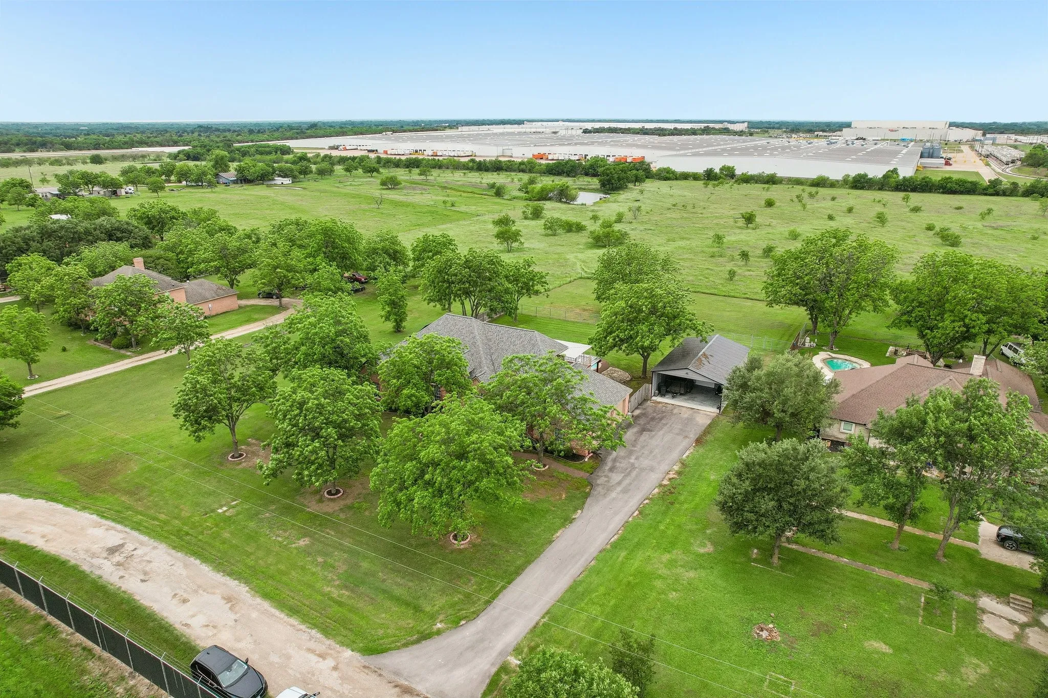 Aerial view of the property showing the entrance and newly added concrete driveway.