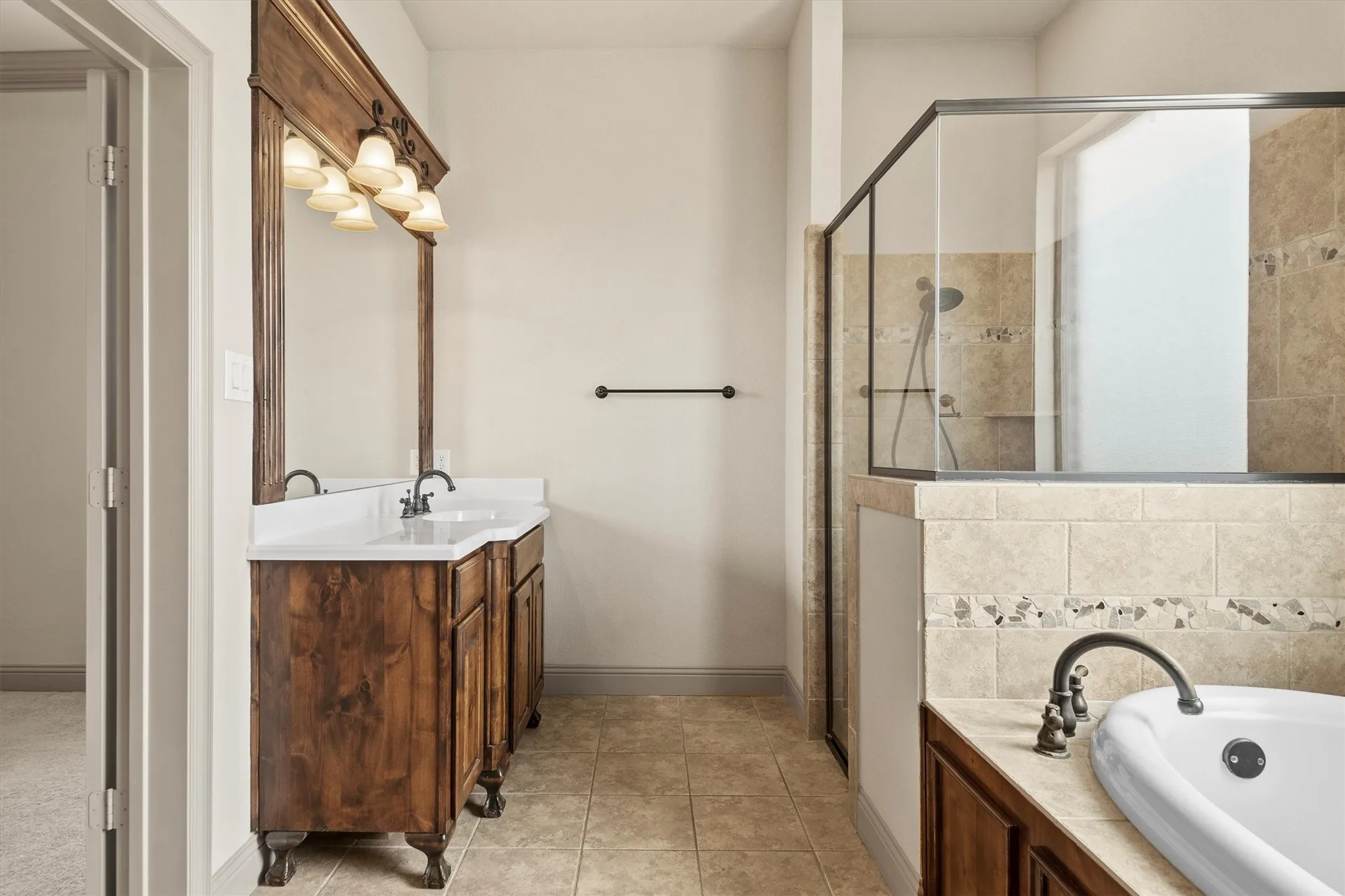Double vanity with wood-finish cabinetry and white countertops