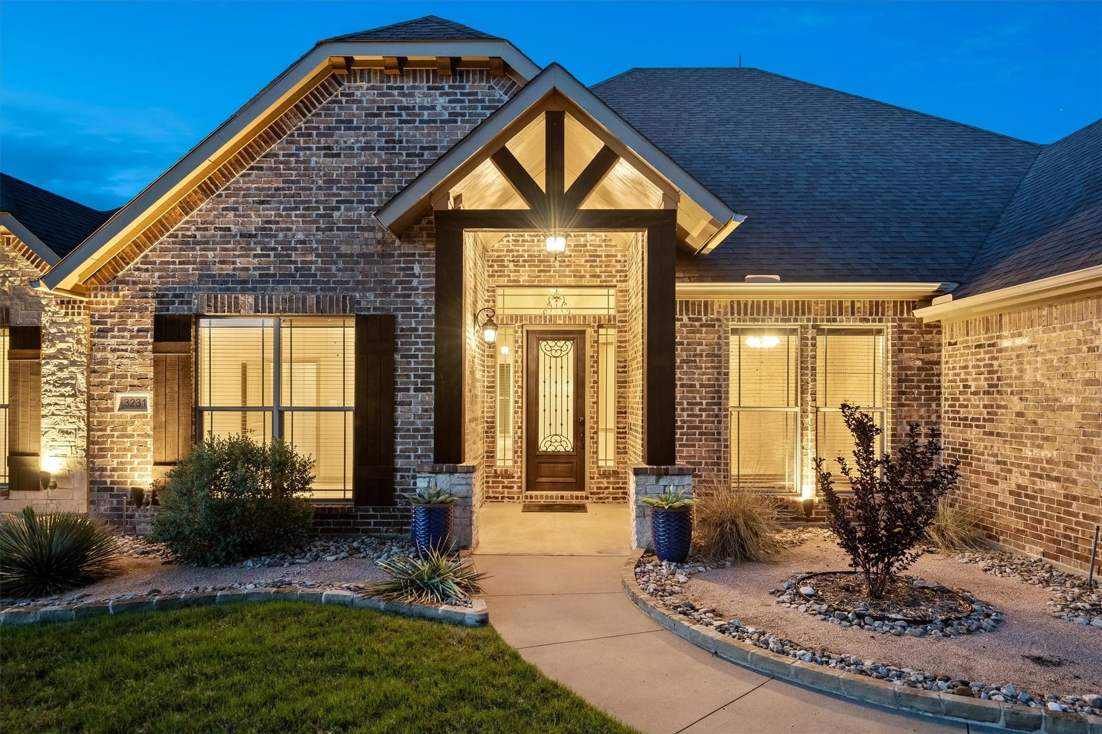 Brick exterior with dark roofline and decorative shutters