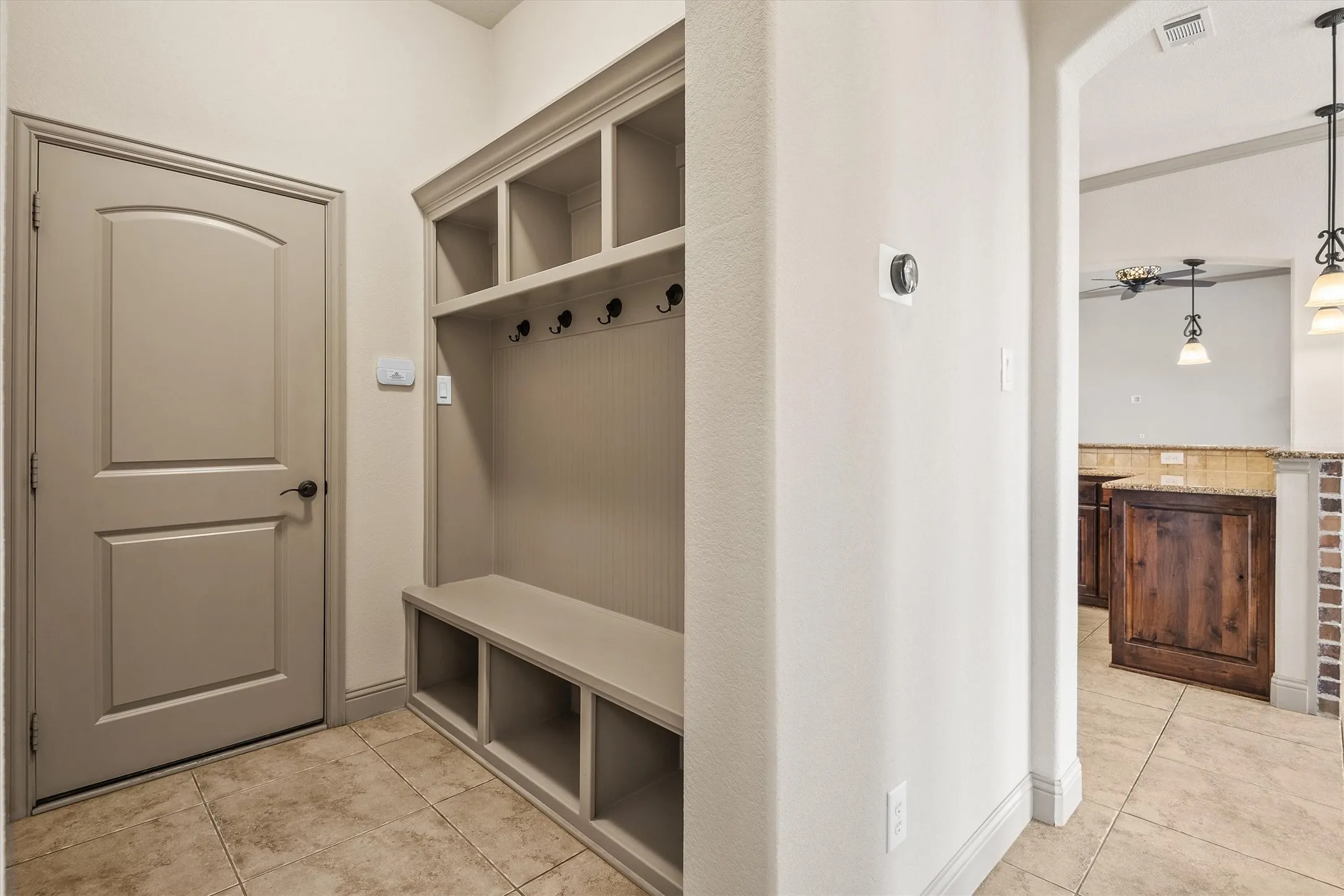 Built-in mudroom bench with cubby storage and coat hooks