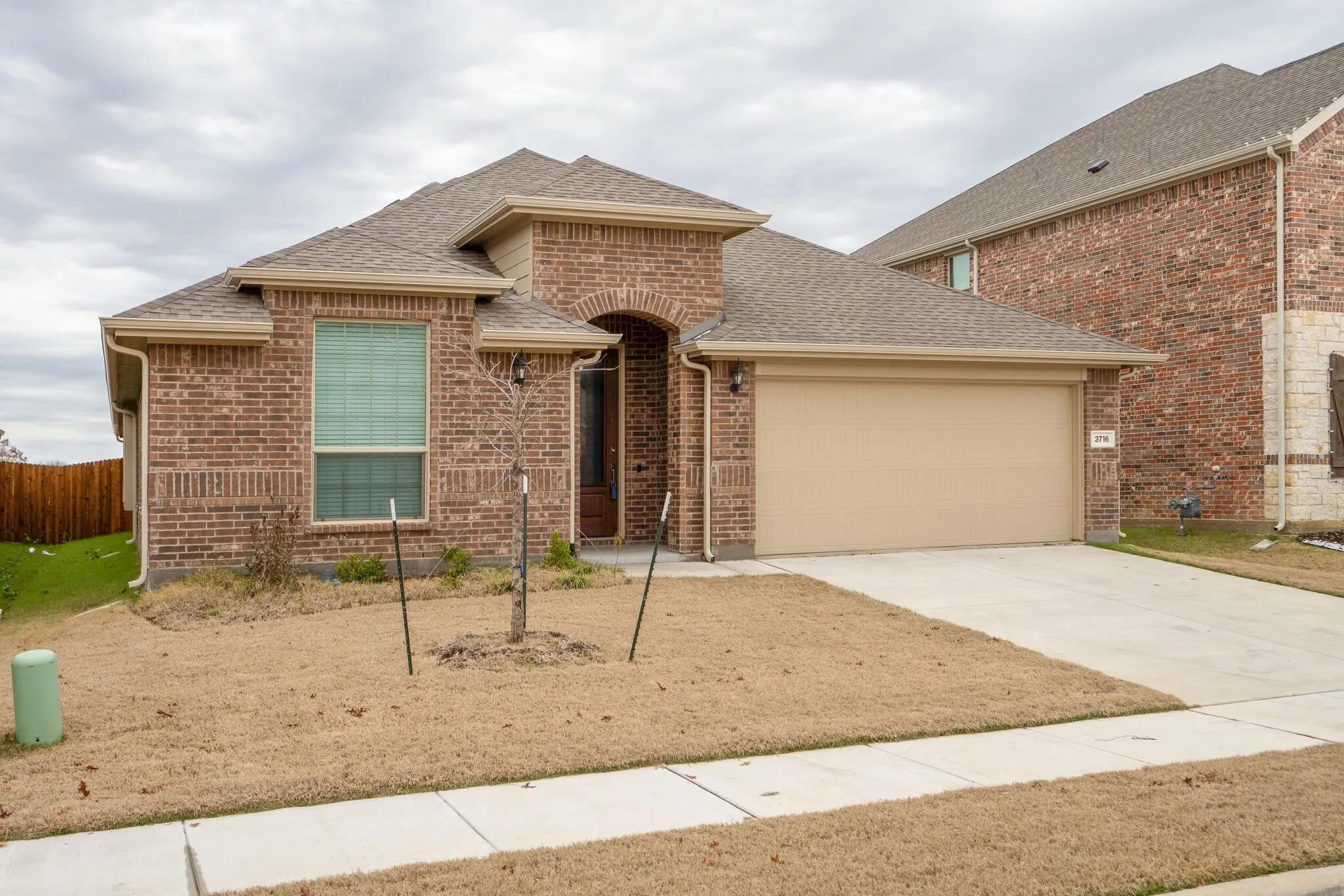 Brick exterior with an arched entryway and covered porch