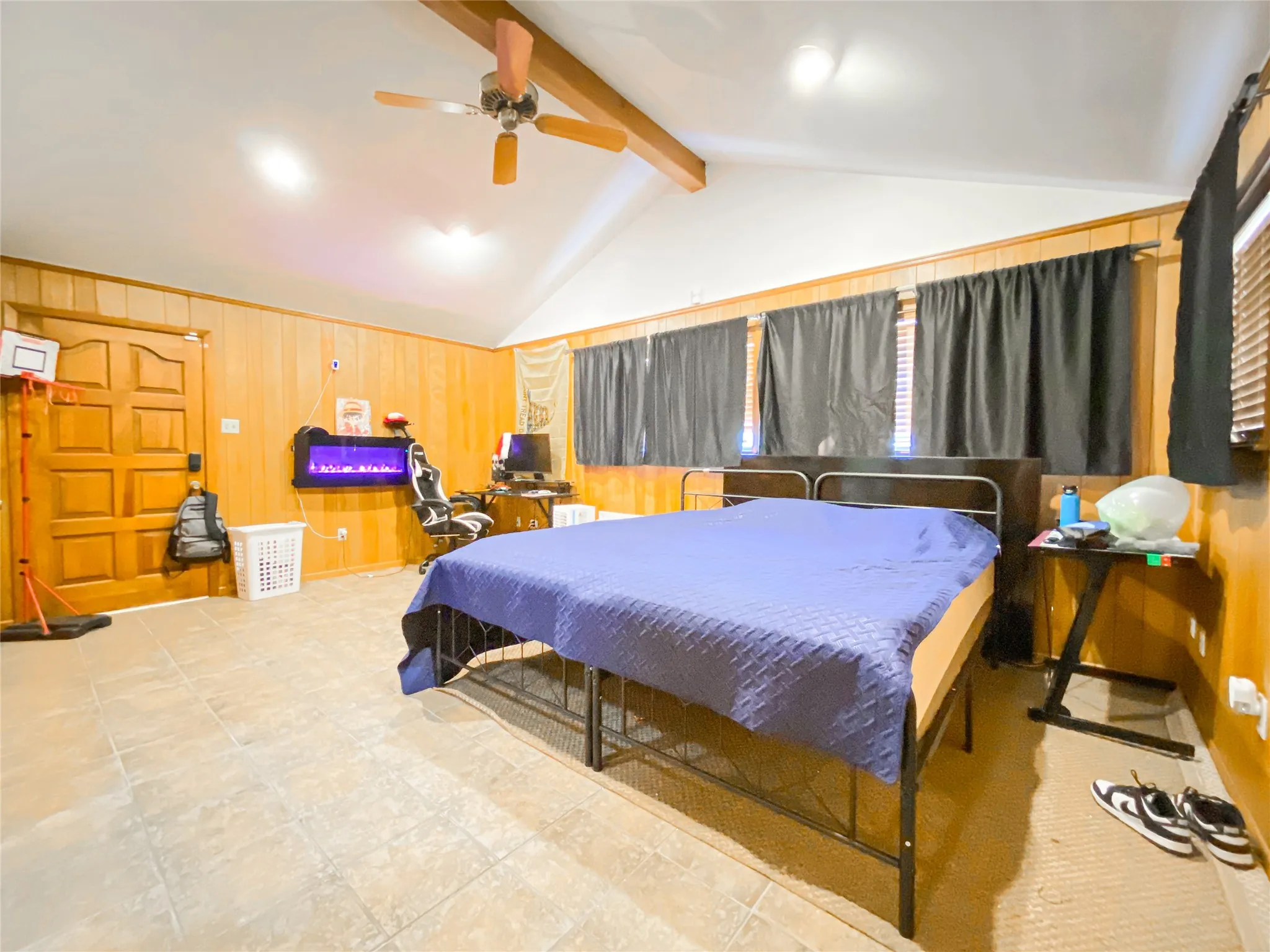 Vaulted ceiling with exposed wood beam and ceiling fan