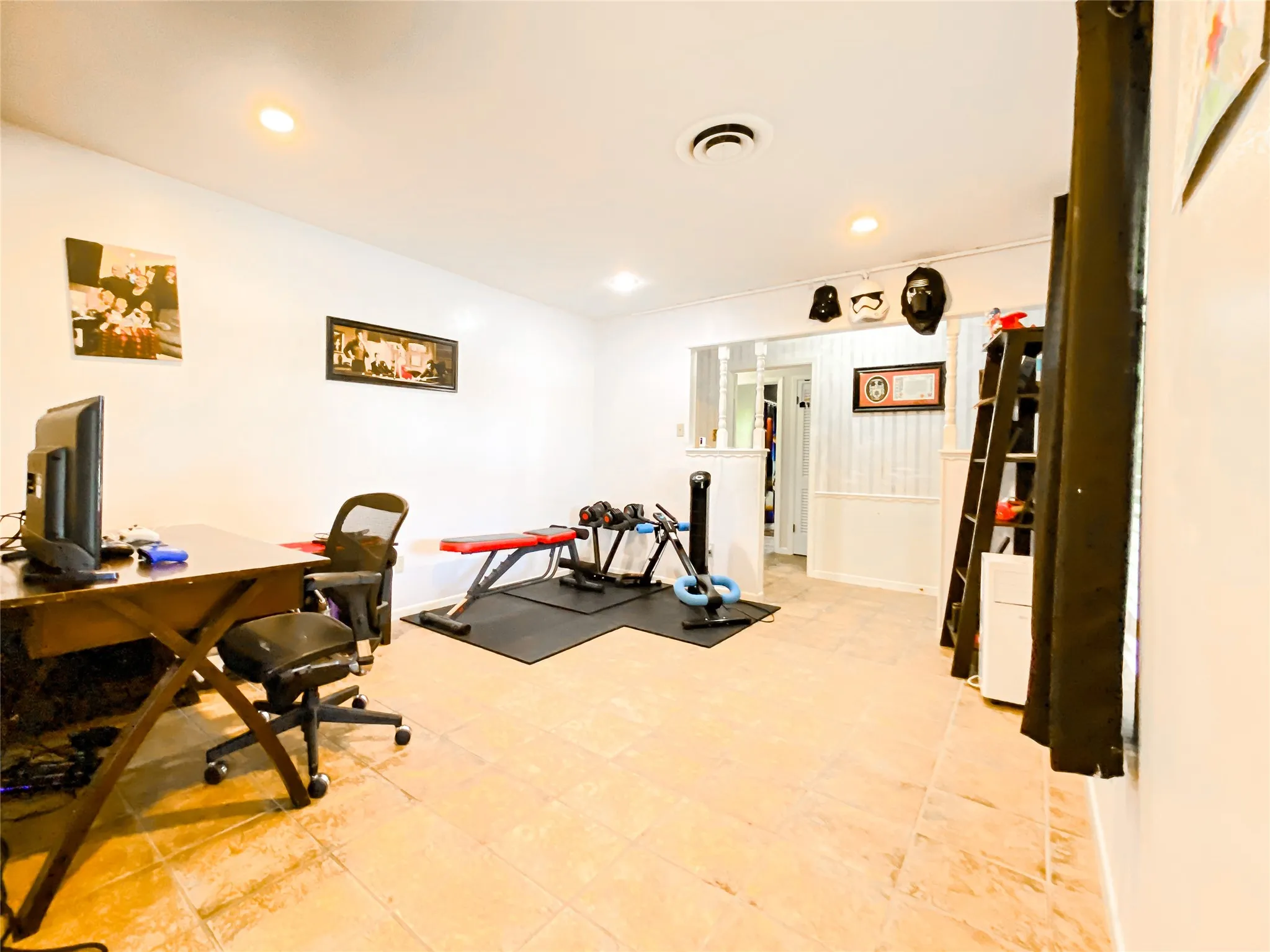 Spacious room featuring light-toned tile flooring and recessed lighting