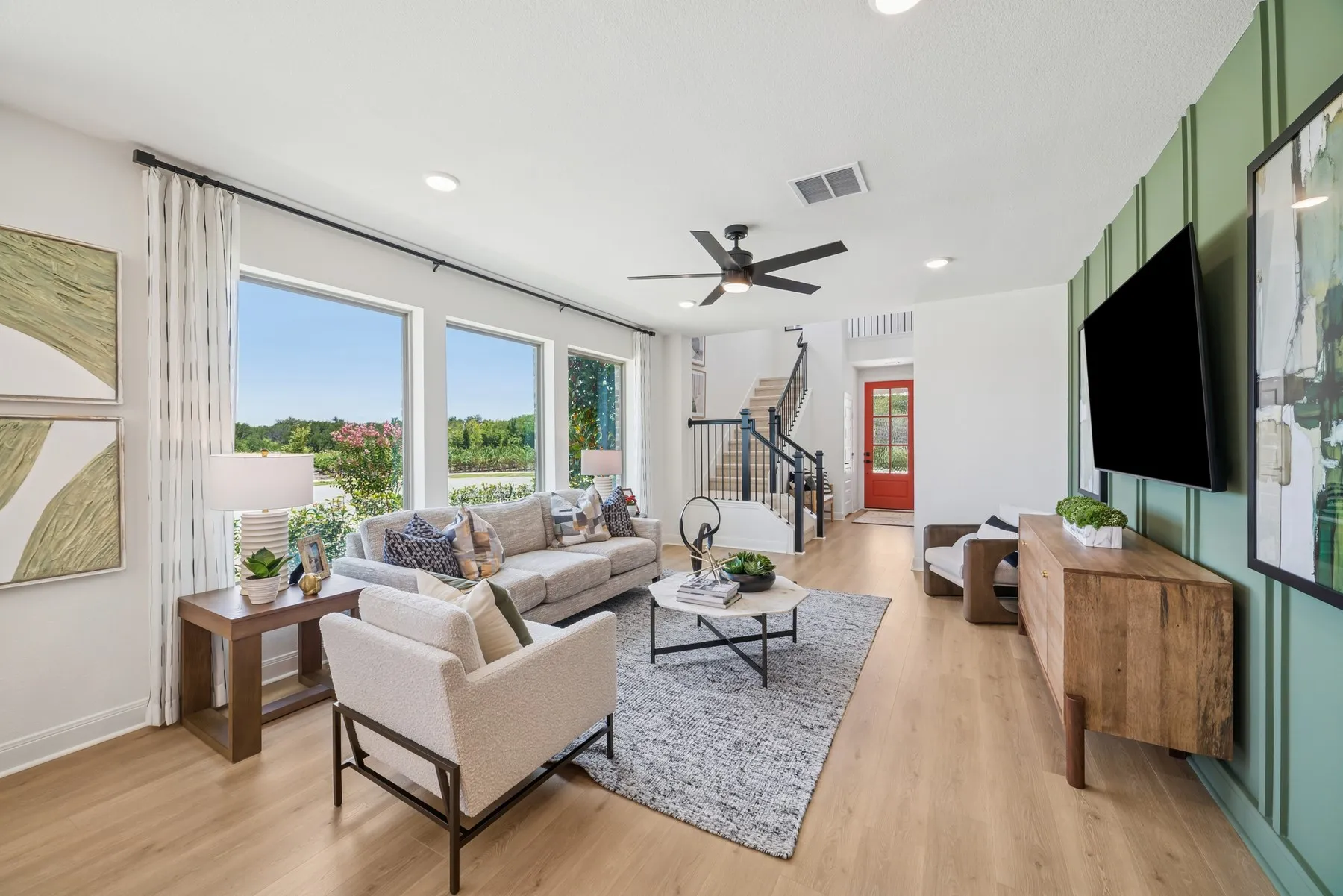 Open-concept living space featuring wood-finish flooring, recessed lighting, and a modern ceiling fan