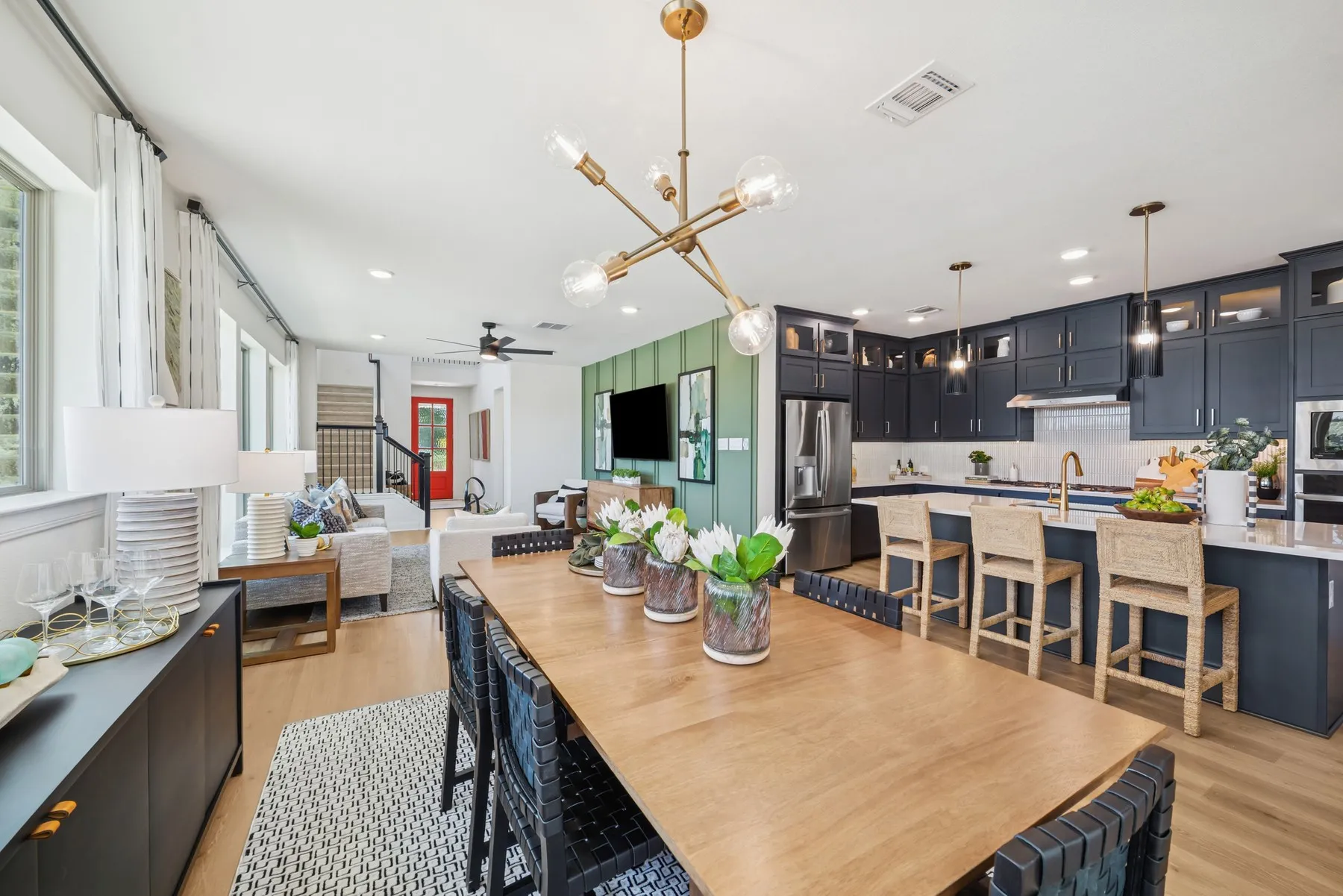 Open-concept dining area with wood-finish flooring, a contemporary chandelier, and recessed lighting