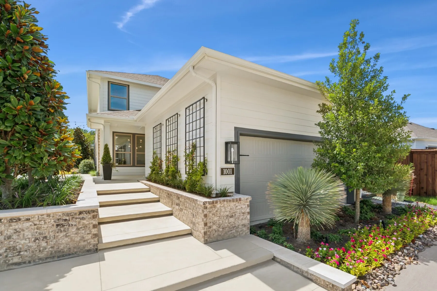 Modern white siding exterior with a prominent two-car garage