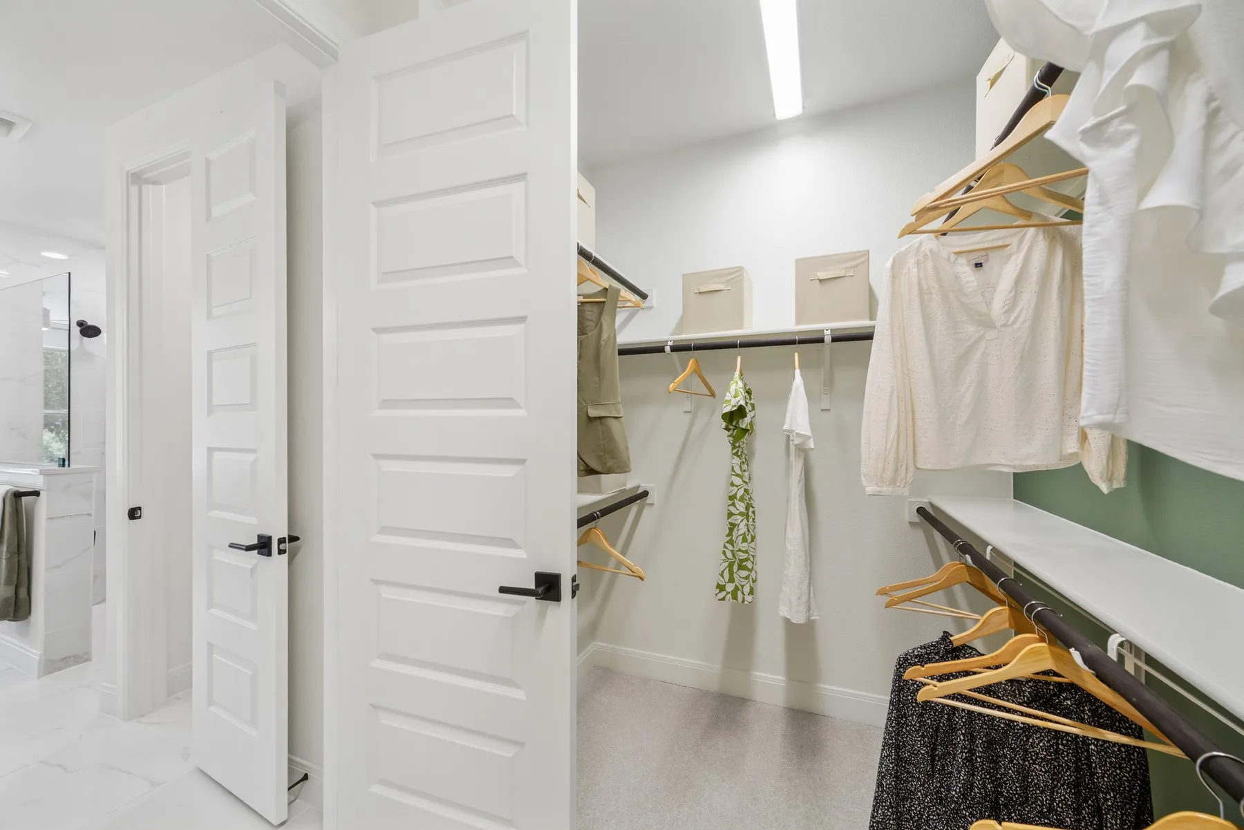 Walk-in closet featuring extensive shelving, multiple hanging rods, and recessed lighting