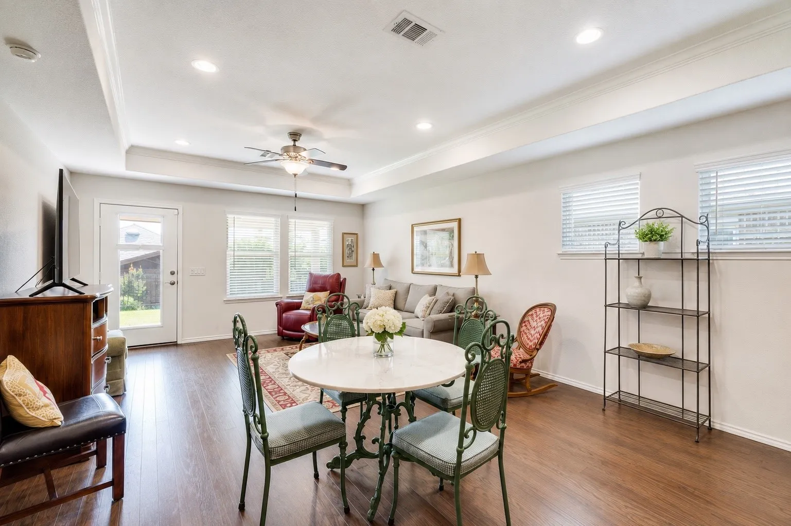 Open-concept living space featuring wood-finish flooring, recessed lighting, and a ceiling fan