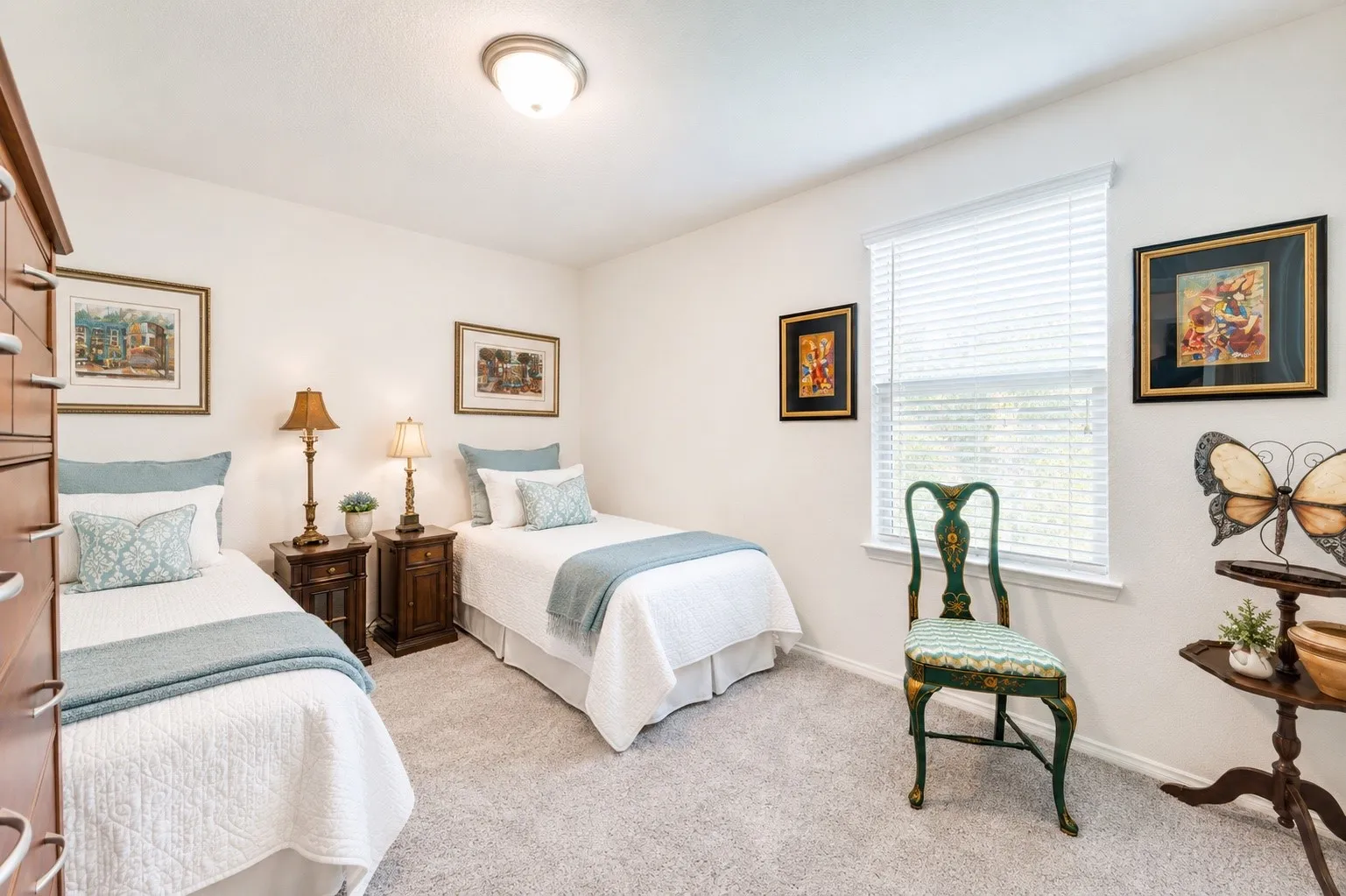 Carpeted room with a ceiling-mounted light fixture, white walls, and a window featuring blinds