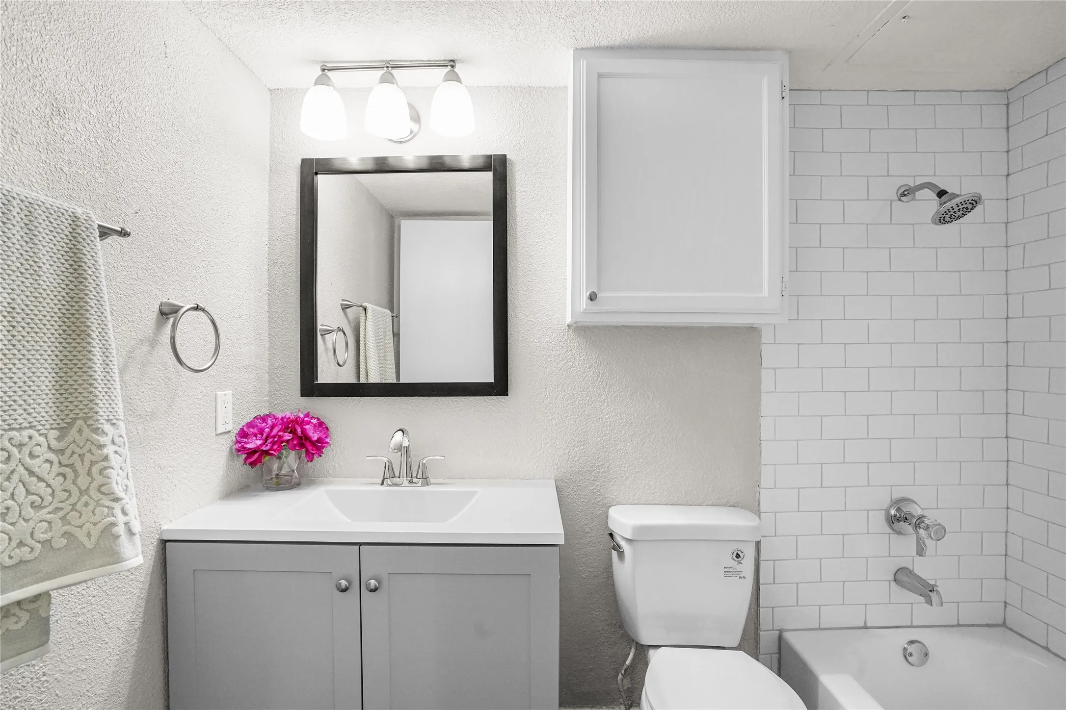 Updated bathroom, with new tub, tile and cabinet.