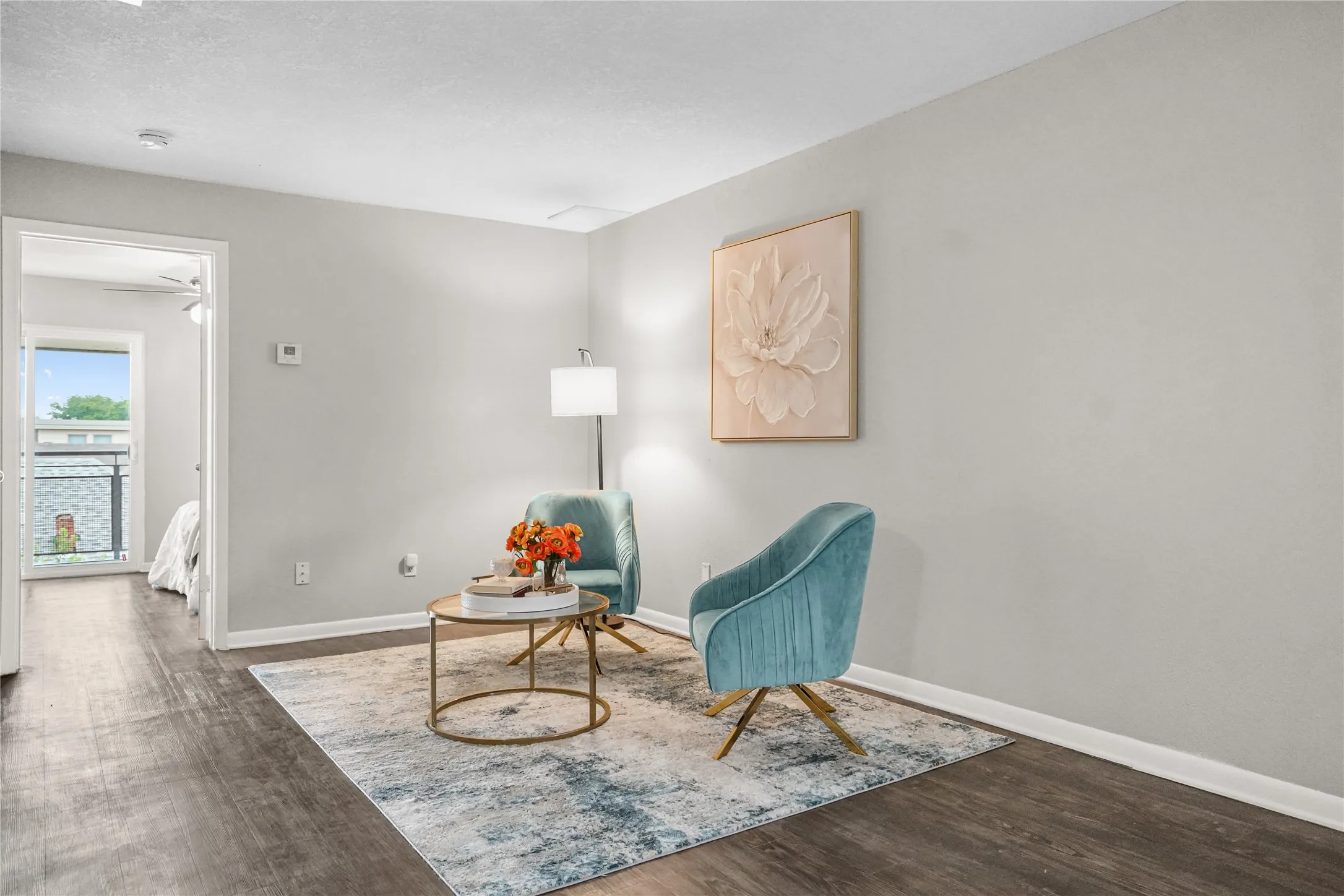 Neutral wall paint complements the wood-looking flooring in this interior space