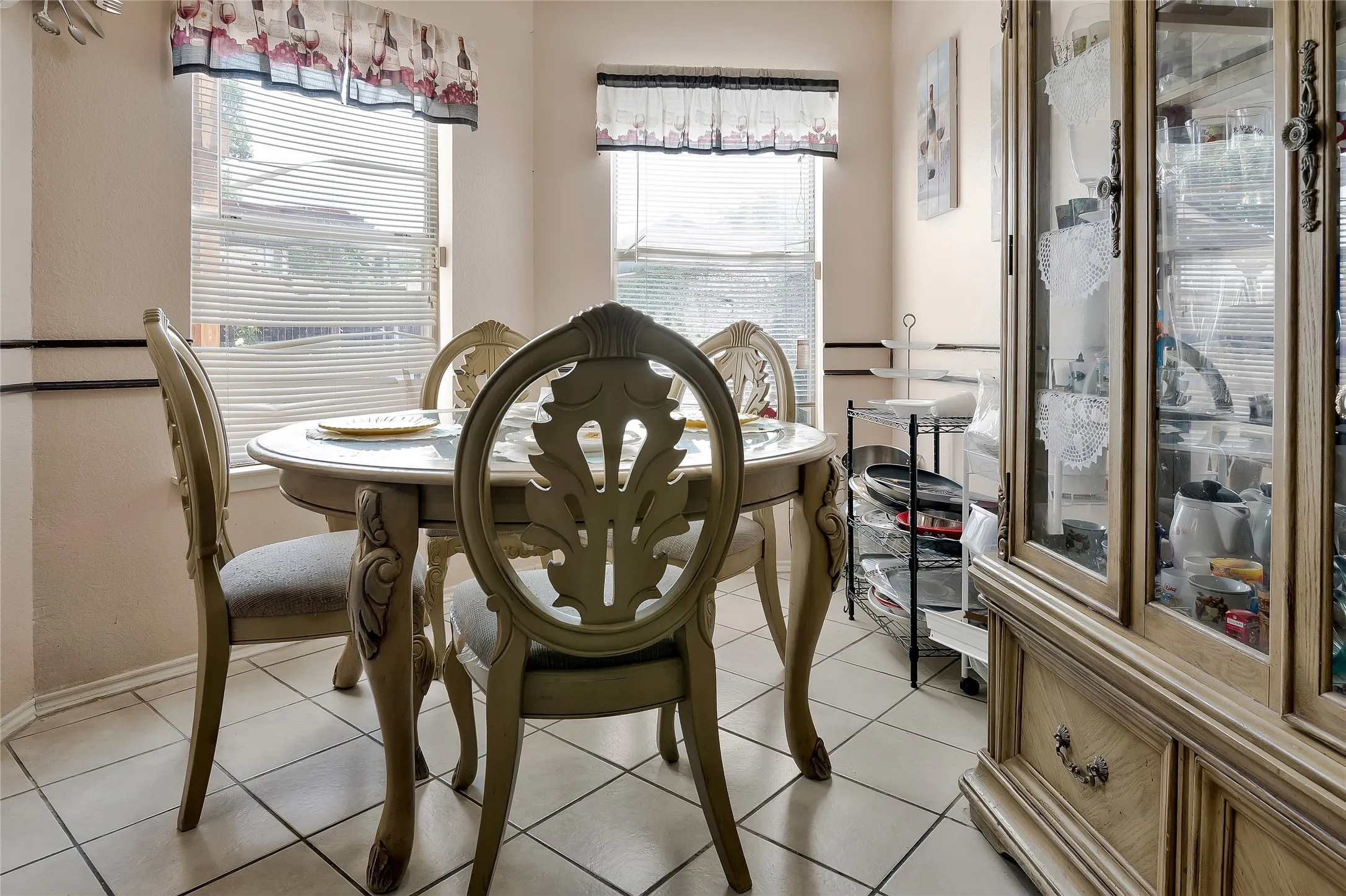 Dining area with light tile patterned floors