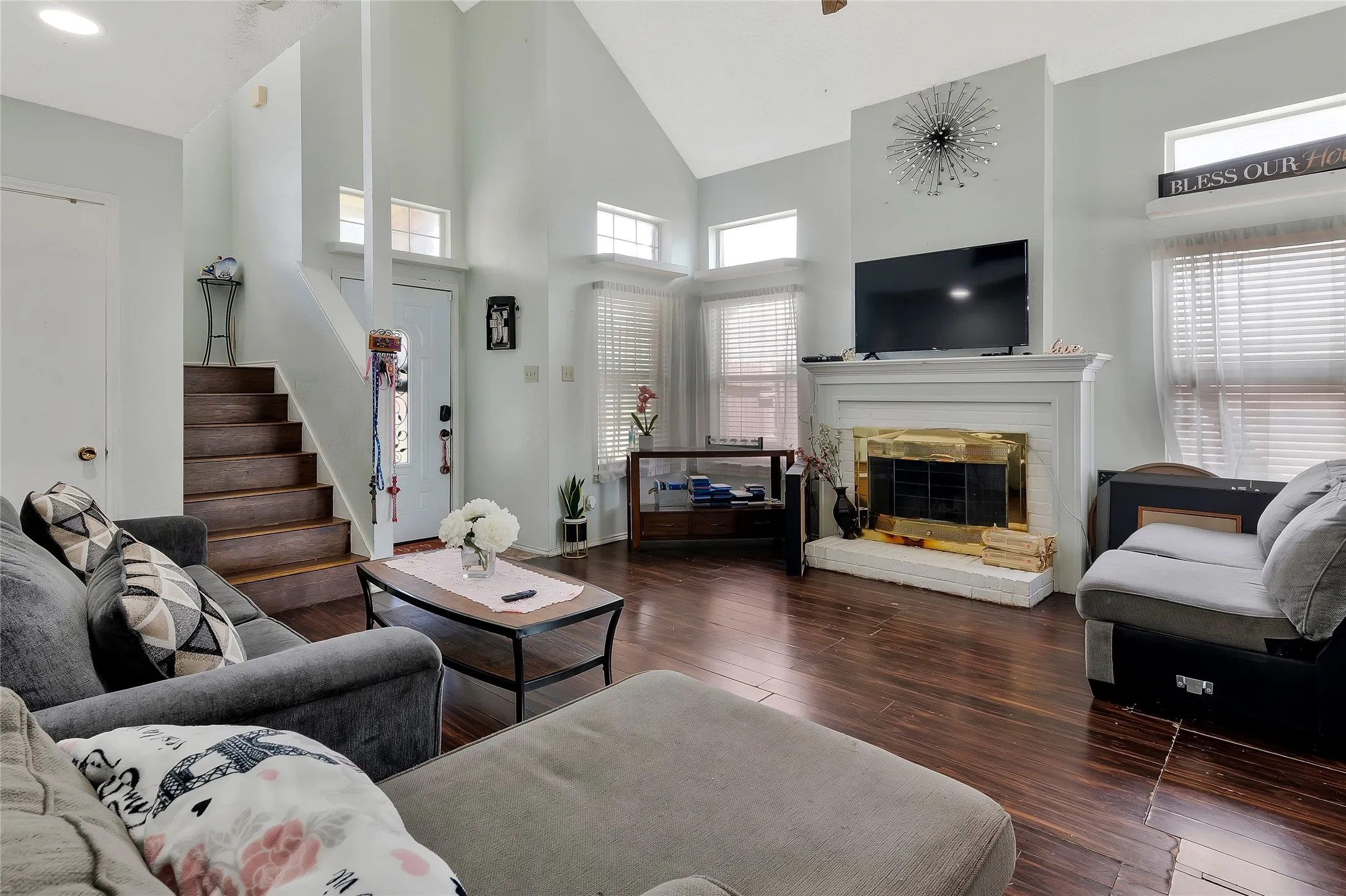 Living room featuring high vaulted ceiling and dark hardwood / wood-style flooring