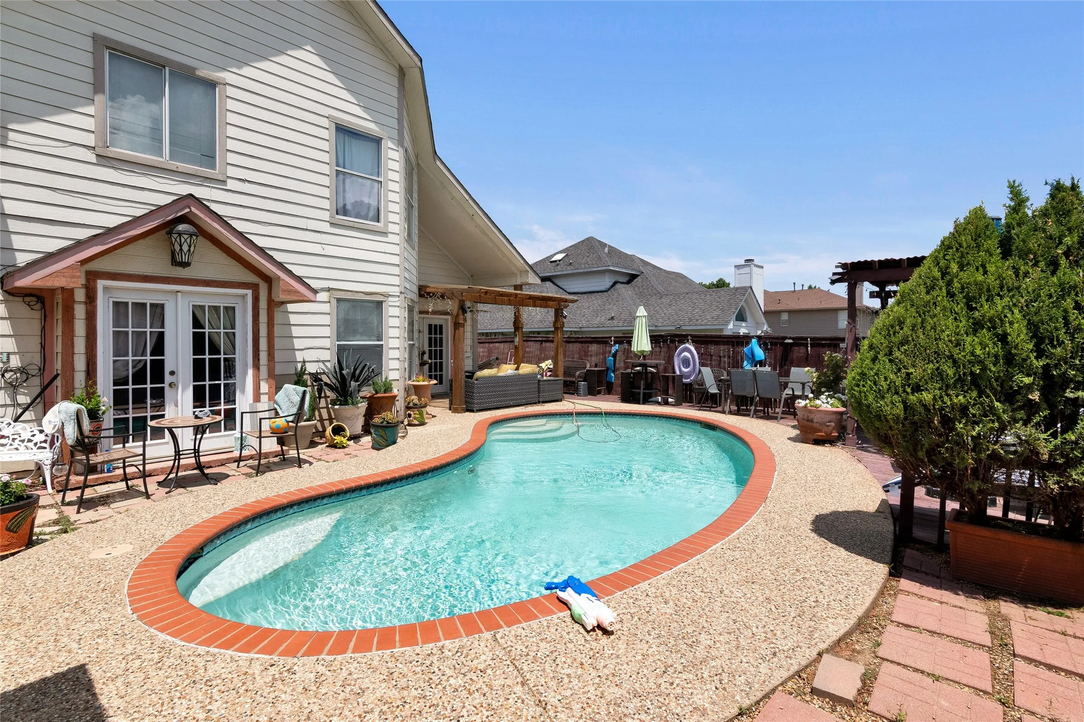 View of pool with french doors, a patio area, and a pergola