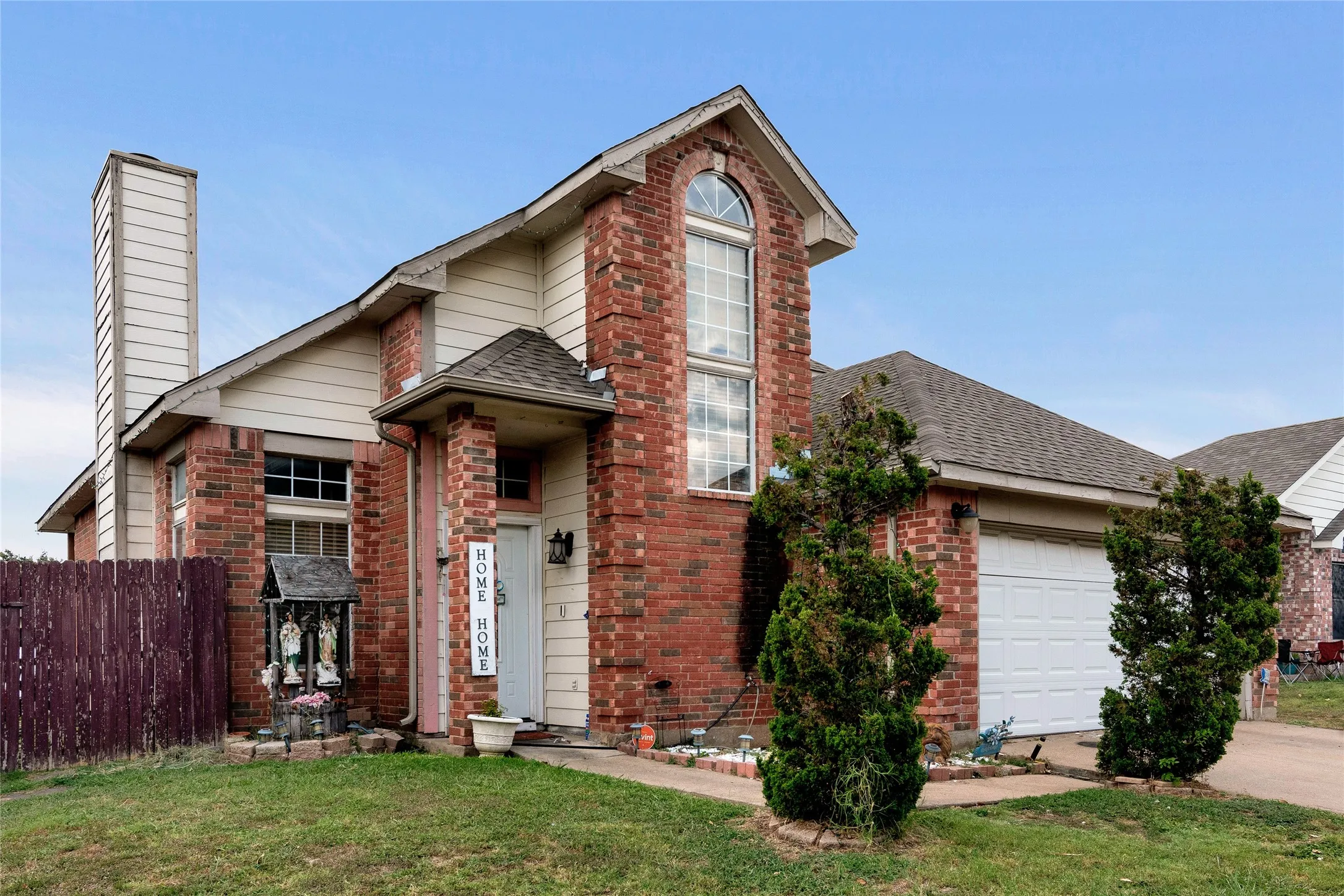 Front of property with a garage and a front yard