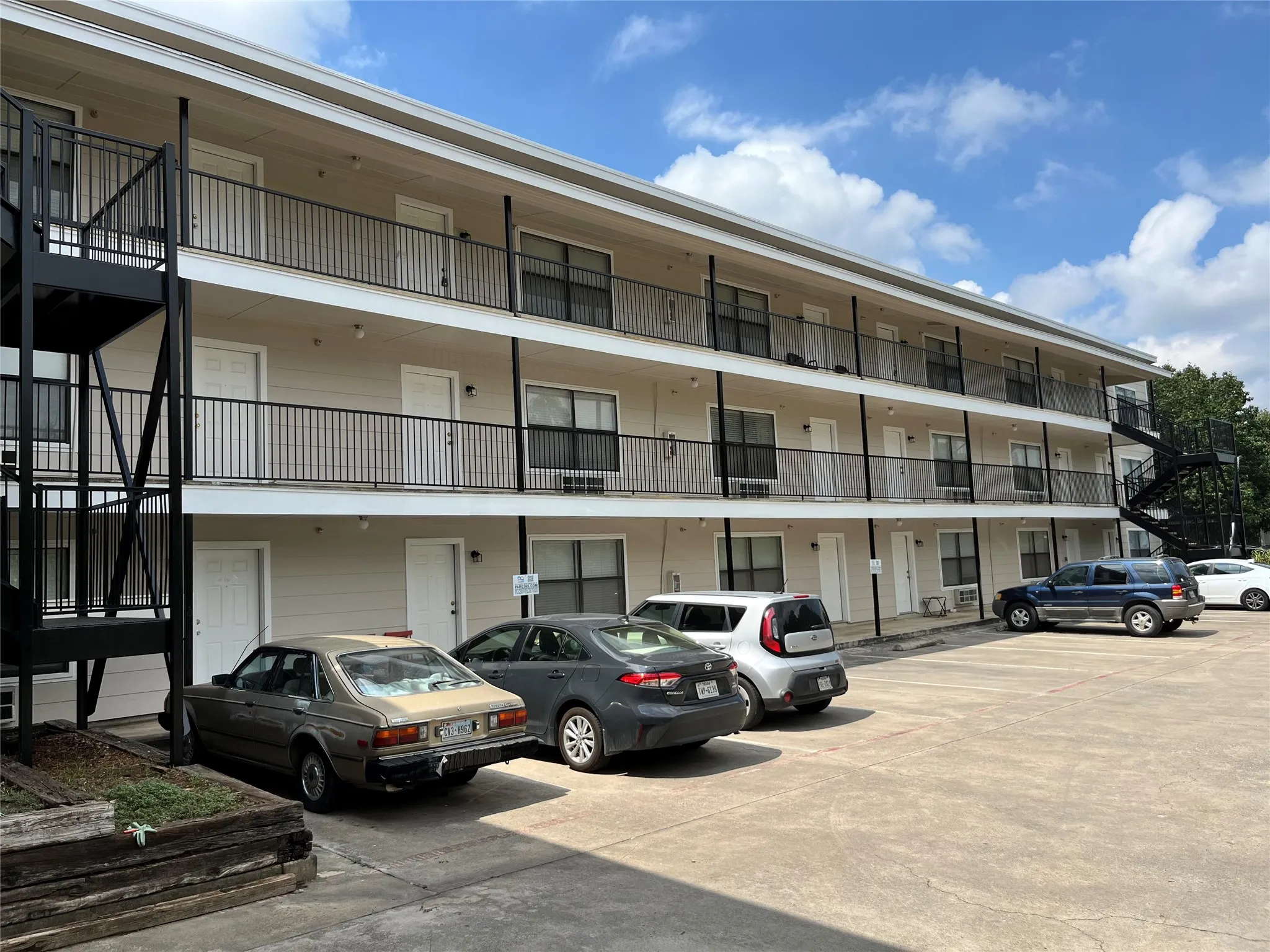 Long view of the building exterior showcasing the consistent maintenance and accessible balcony walkways.