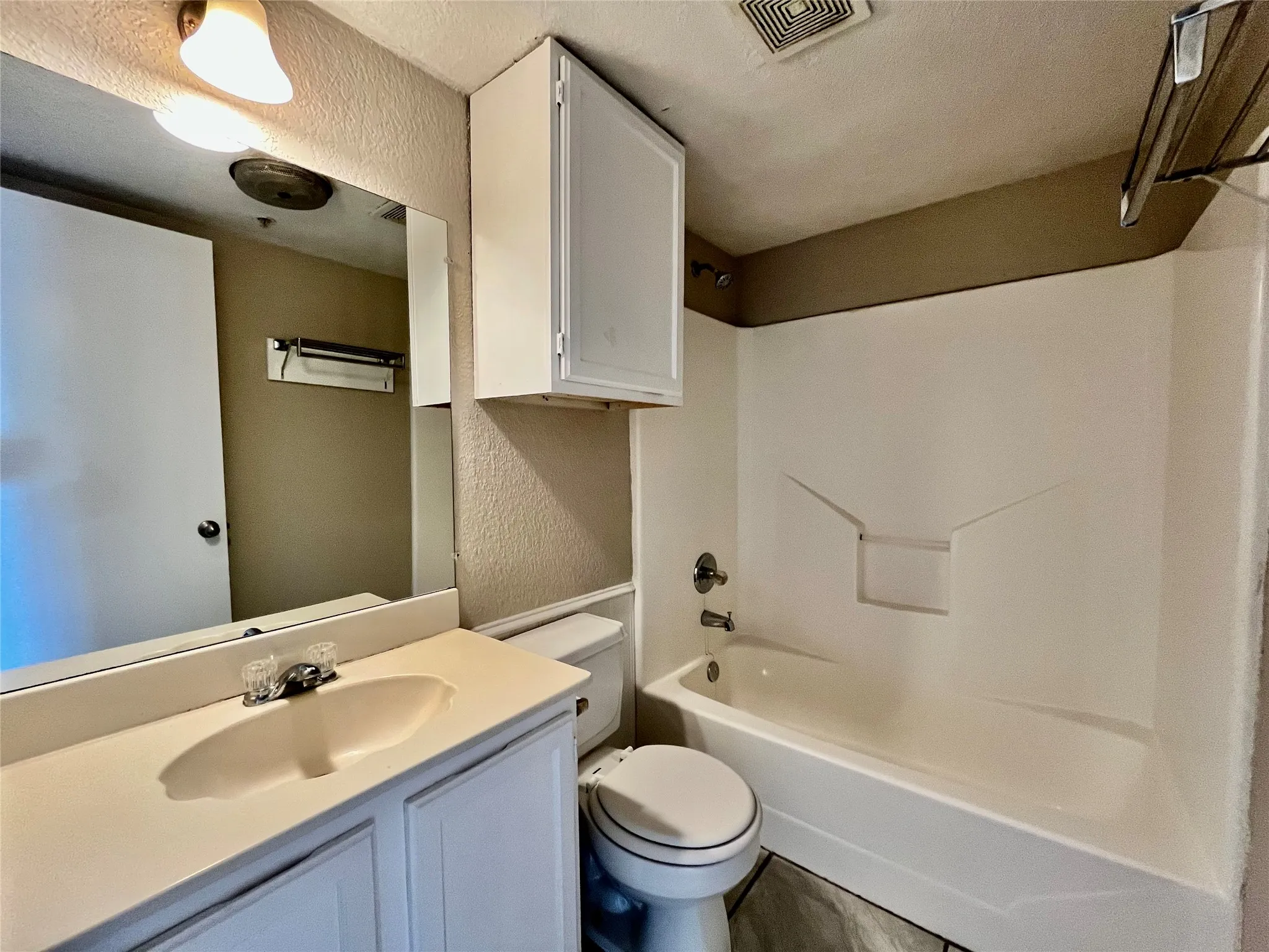 Updated bathroom featuring a full tub/shower combo, modern vanity, and bright lighting.