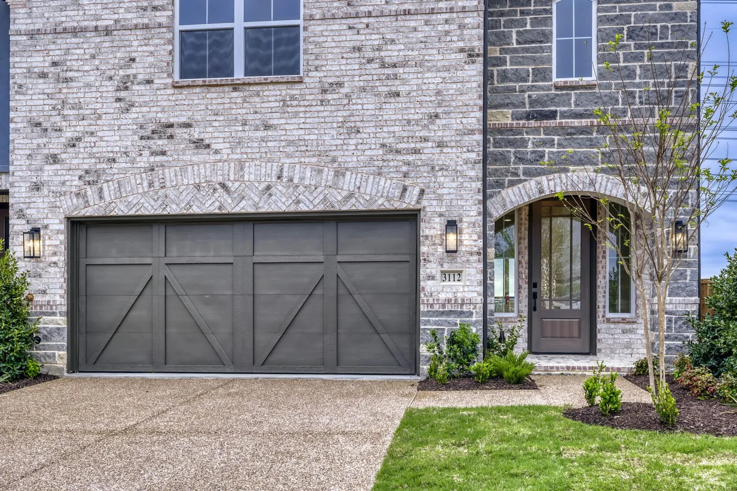 Brick facade with stone accents and a complementary arched entryway