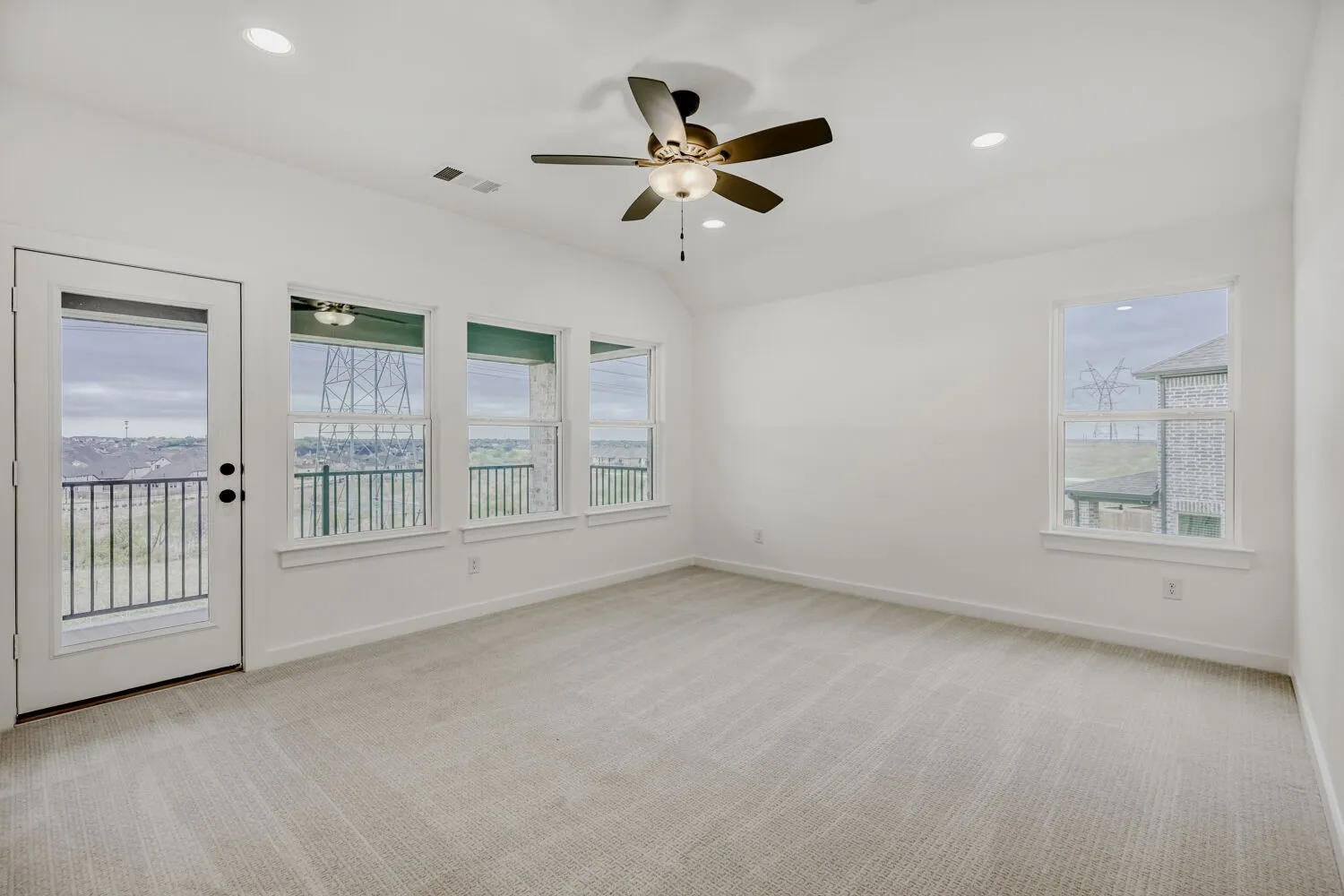 Carpeted room with white walls, recessed lighting, and a ceiling fan