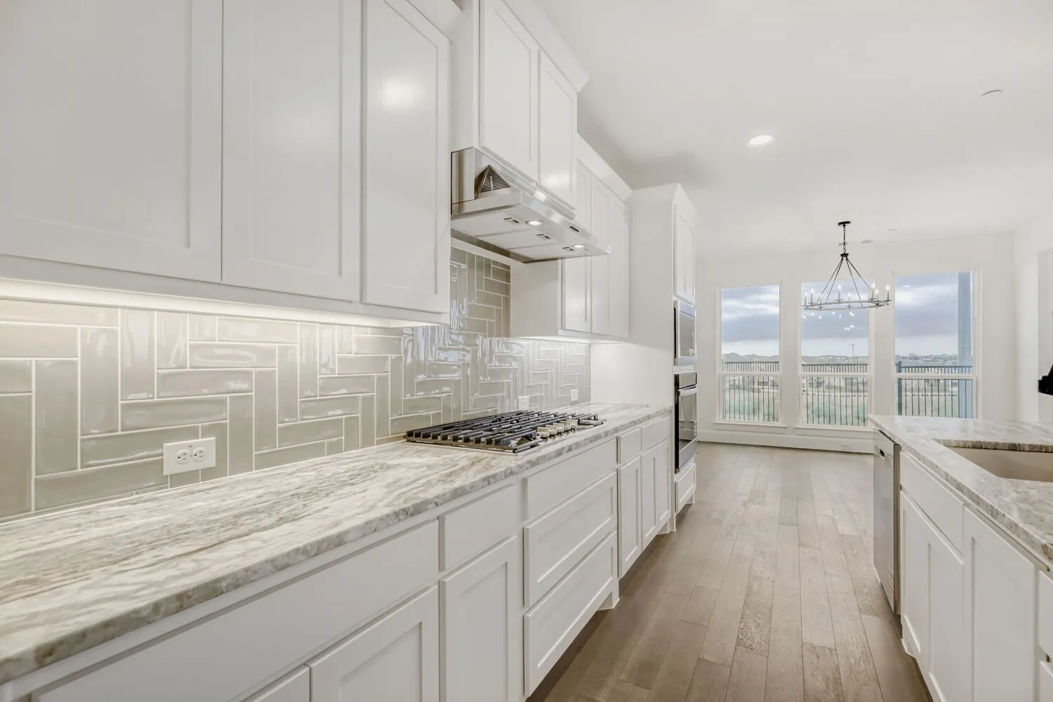 White shaker cabinetry with under-cabinet lighting