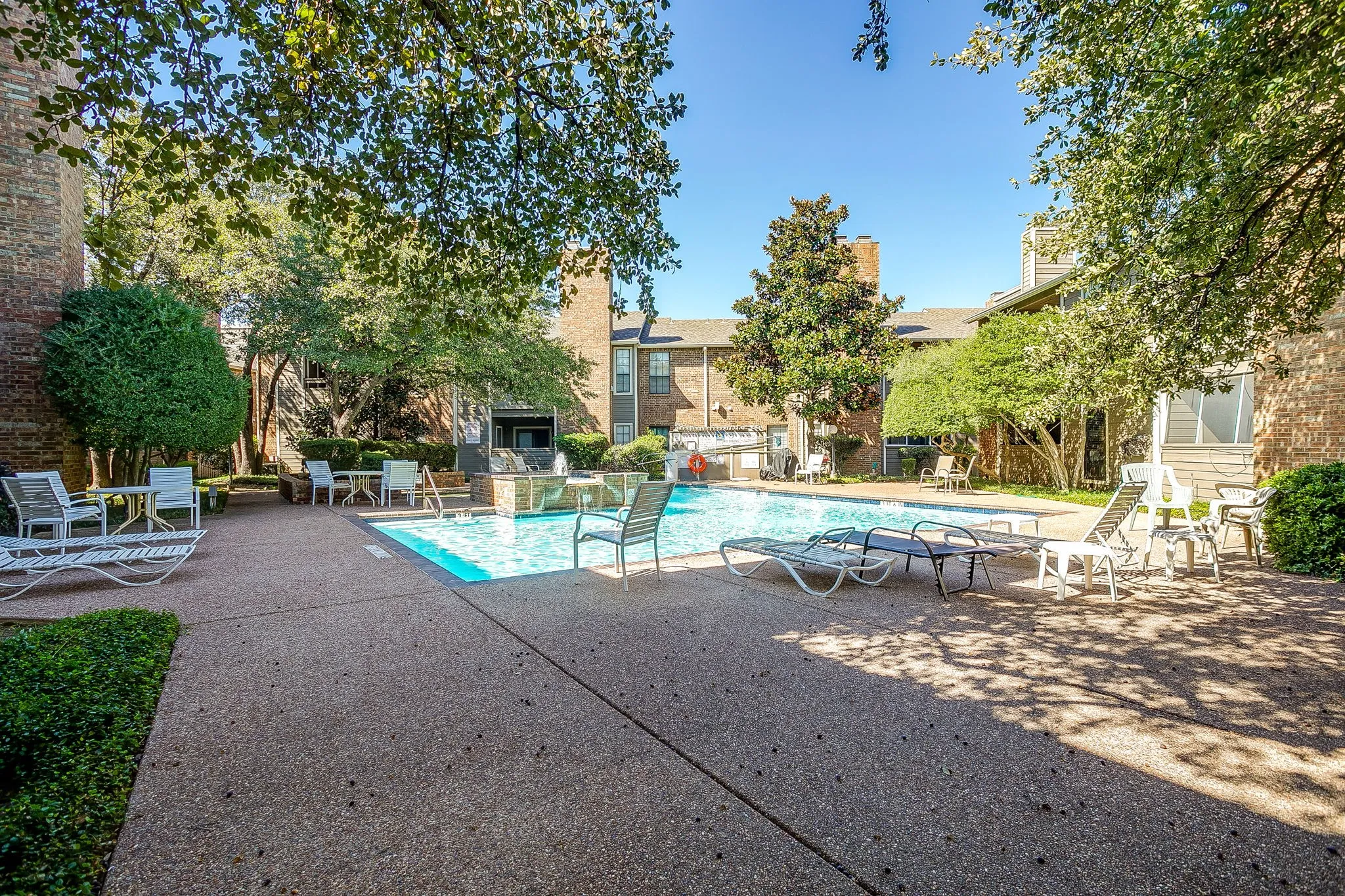 Swimming pool with surrounding concrete patio