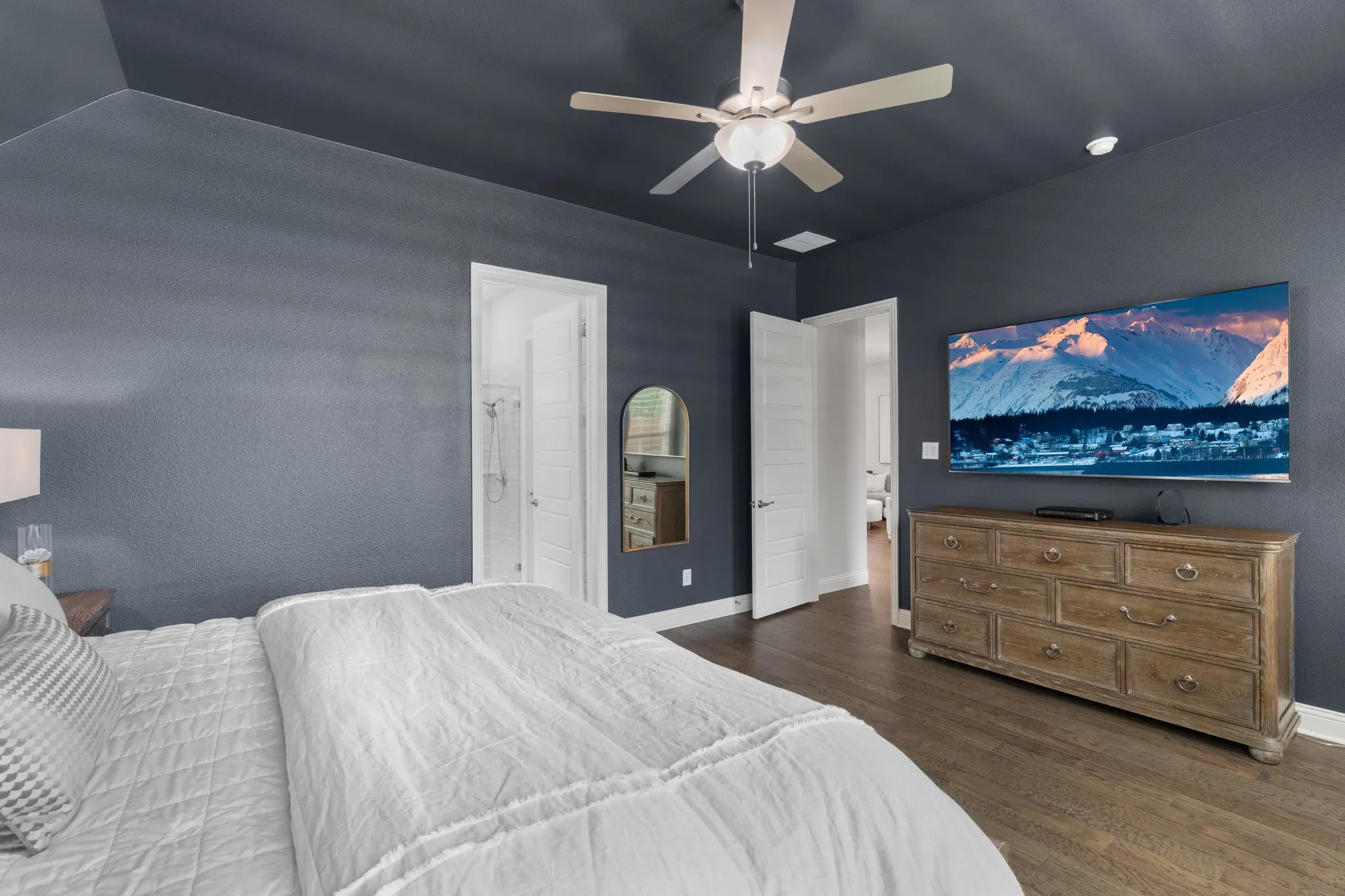 Spacious primary bedroom currently hosts a king-size bed with plenty of room for a sitting area too.