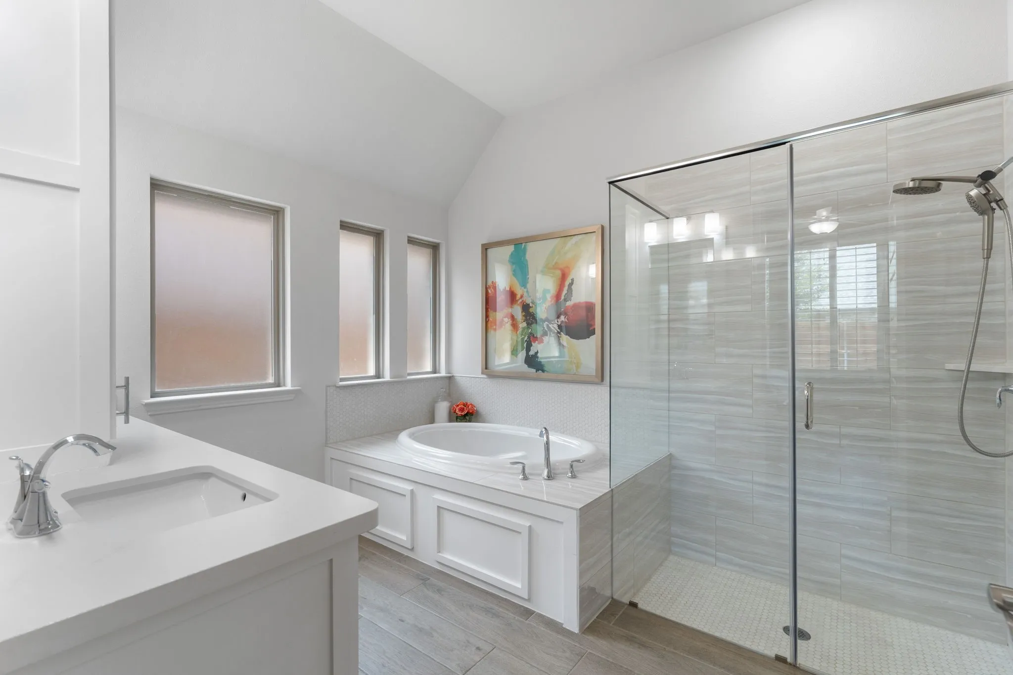 Note the wide walk-in shower with decorative wall tile that compliments the floor tile.
